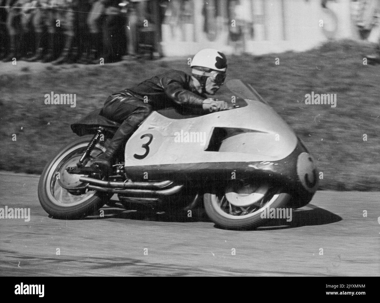 Duke Does it Again - Reg Armstrong of Australia piloted his Gilera to third place in the 500 C.C. Race at Hockenheim, behind Geoff Duke and Ken Kavanagh. Geoff Duke, Britain's World 500 CC Motorcycle Champion Robe his 500 CC Gilera to victory in the Rhine cup races at Hockenheim, Germany on Sunday. More than 120,000 fans saw him set up a lap record of 123.83 miles an hour. He covered the 20 laps in 47 minutes 12.5 seconds. Ken Kavanagh of Australia was second in this event and also won the 350 CC Race on his Moto-Gizzi at 111.84 miles an hour. May 10, 1955. (Photo by Paul Popper). Stock Photo