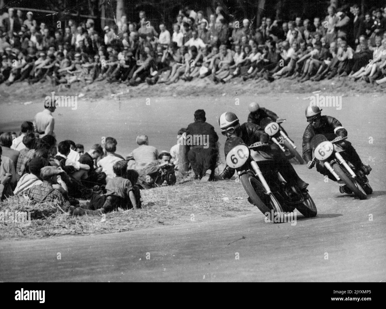 Duke wins in Germany - In the 350 cc event Geoffrey Duke (60) leads Johnny Lockett (65), of Britain who was second, and Ken Kavanagh of Australia (70) who was third. All are driving British Norton machines. British Geoffrey Duke set two new track records at the ***** race course near Stuttgart, August 26, when he won both the major events of the German motor-cycle Grand Prix. He won the 500 cc event at an average of 136 kmph (about 84.5 mph) and the 350 cc event at 130.6 kmph (about 81 mph). September 8, 1951. Stock Photo