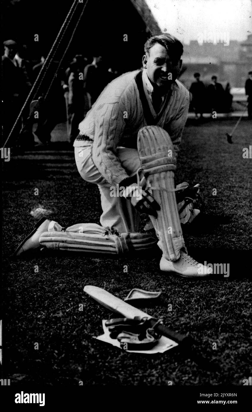 The Australians Practice At Lords -- N.D. Ring putting on his pads in readiness for a turn at the nets. Following their arrival in London, the Australians under captain Don Bradman, were visiting Lords and getting in a little loosening up practice. Victorian Doug Ring, with the Australian cricket team in England puts on the ***** for a practice knock at Lords. April 19, 1948. (Photo by Sport & General Press Agency, Limited). Stock Photo