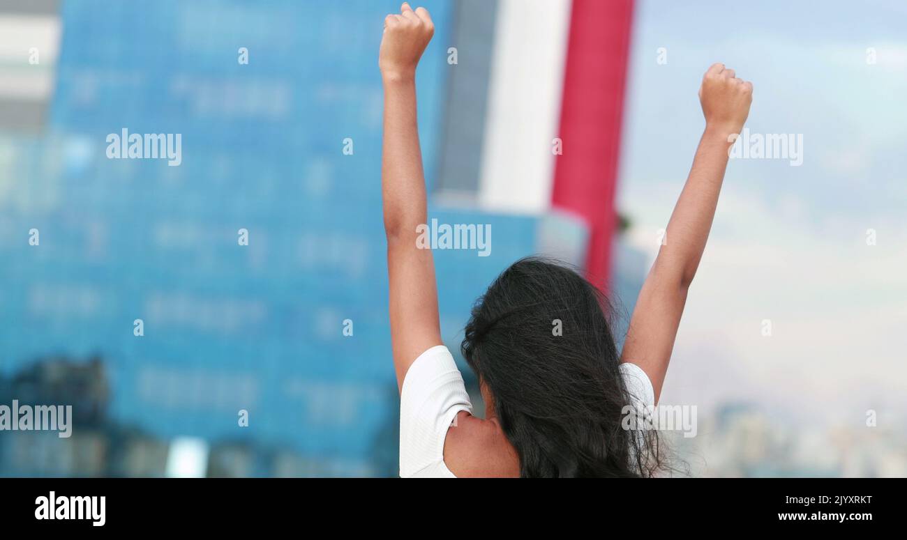 Young black african woman raising arms in victory Stock Photo - Alamy