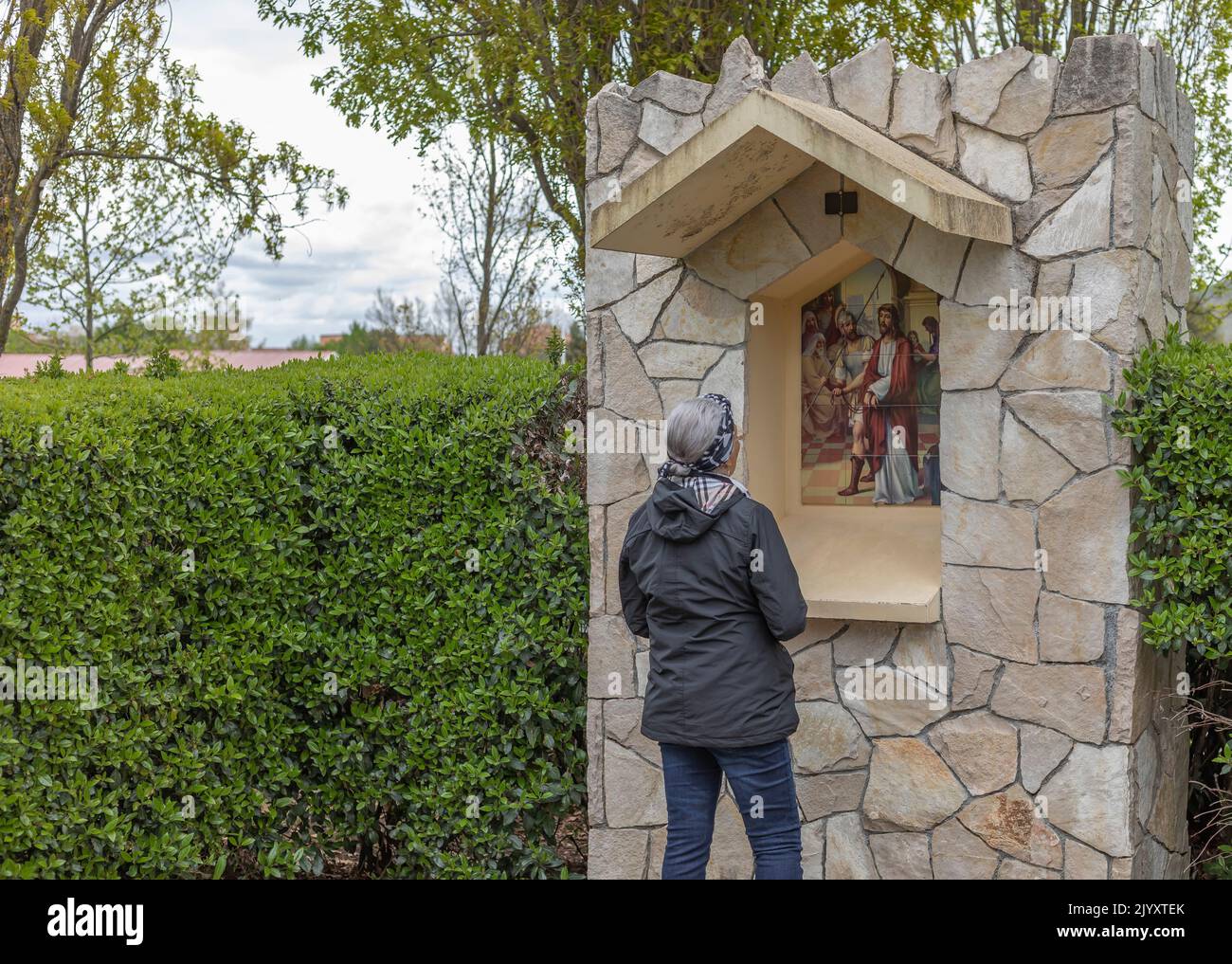 Medjugorje, Bosnia and Herzegovina - April 23rd, 2022 - Worshipper at the religious site in Medjugorje looking at the depiction of the story of Christ Stock Photo