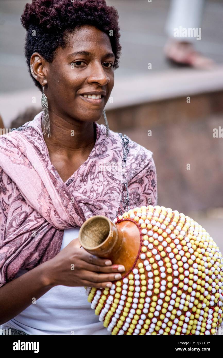 Salvador, Bahia, Brazil - September 17, 2016: Woman playing Abe or Xequere, percussion musical instrument created in Africa. Salvador, Bahia, Campo Gr Stock Photo