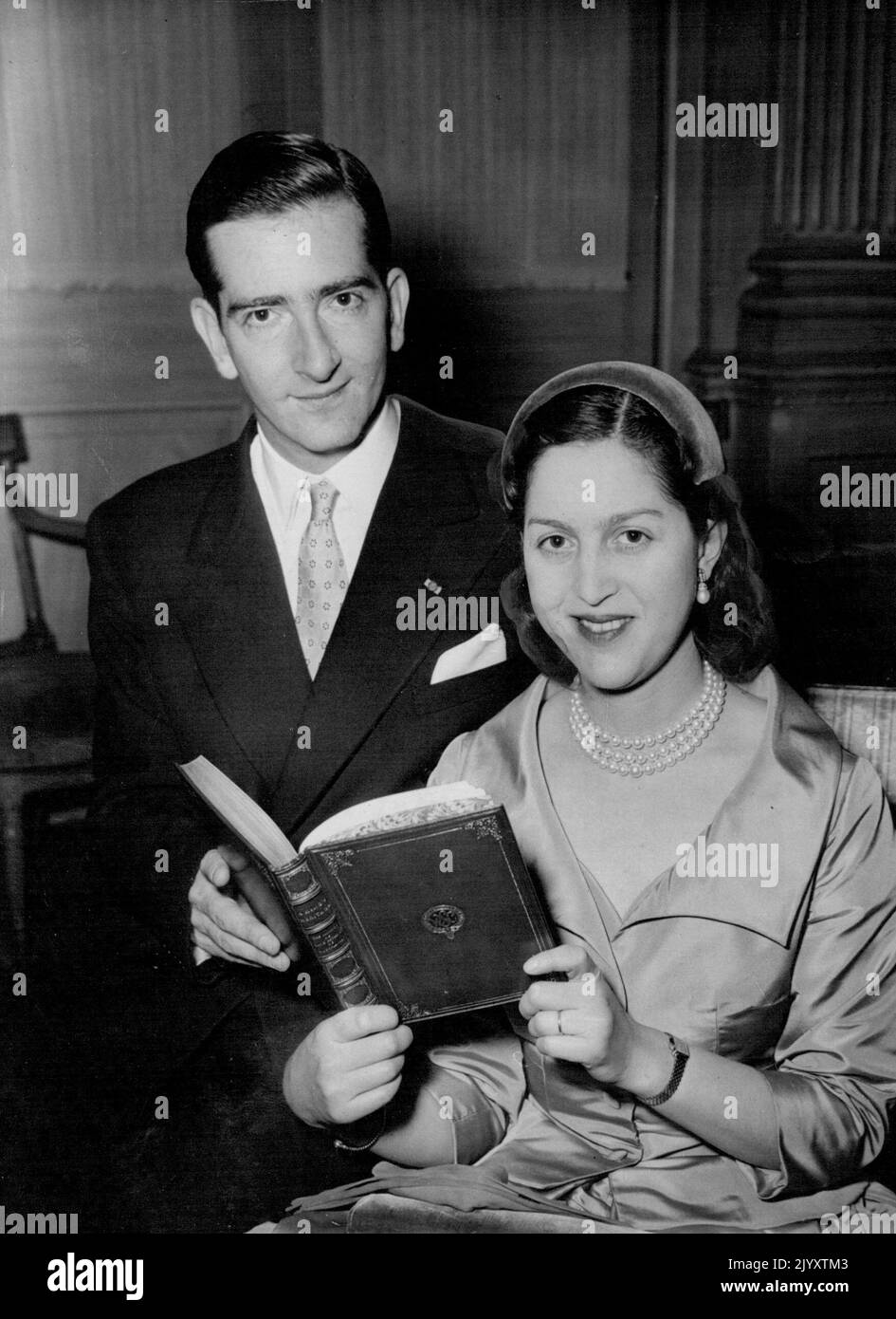 Ex-King Peter Publishers His Memories Holding a copy of his memoirs 'A King's Hertage' is ex-King Peter of Yugoslavia with his wife ex King Queen Alexandra at Claridges Hotel in London this afternoon (Wednesday). The book is to be published tomorrow and the former King and Queen, who were recently reconciled flew into London yesterday in connection with the Publication. March 23, 1955. (Photo by Reuterphoto) Stock Photo