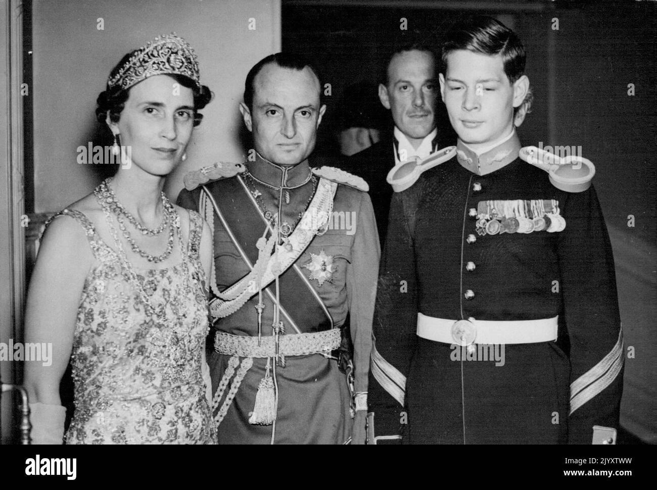 Coronation Ball at the Albert Hall Photo Shows: Prince and Princess Paul of Yugoslavia with Crown Prince Michael of Romania (right) seen at the Ball. A coronation costume ball was held at the Albert Hall tonight May 13. June 07, 1937. (Photo by Associated Press Photos) Stock Photo