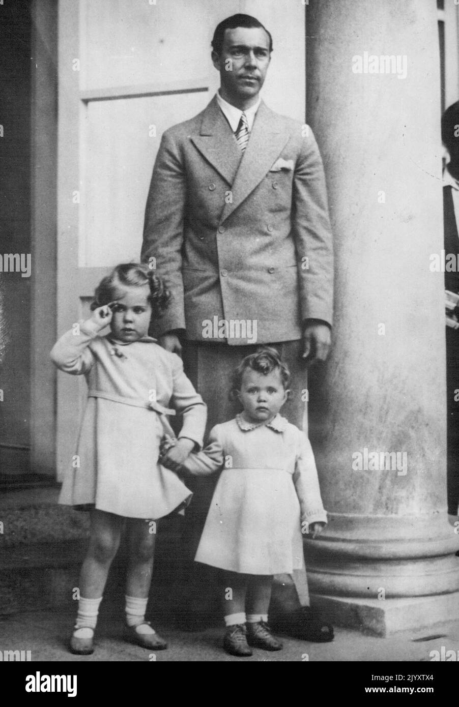 Swedish girl scouts give their congratulation gifts of lowers to Princess Sibylla, of Sweden who recently gave birth to her third daughter Princess Desiree. Her other two daughters the Princess Margaretha and Birgitta with their father Prince Gustaf Adolf, received the gifts at the Palace in Stockholm. Princess Margaretha giving the scouts salute with Princess Birgitta and their father Prince Gustaf Adolf when the gifts of flowers were received. June 08, 1938. (Photo by Sport and General Press Agency Limited) Stock Photo