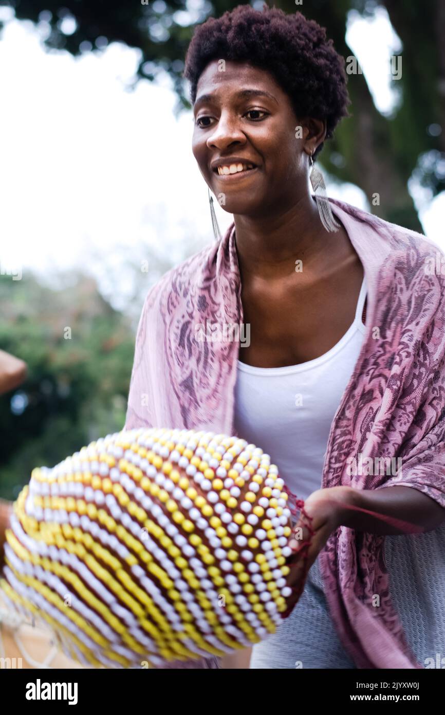 Salvador, Bahia, Brazil - September 17, 2016: Woman playing Abe or Xequere, percussion musical instrument created in Africa. Salvador, Bahia, Campo Gr Stock Photo