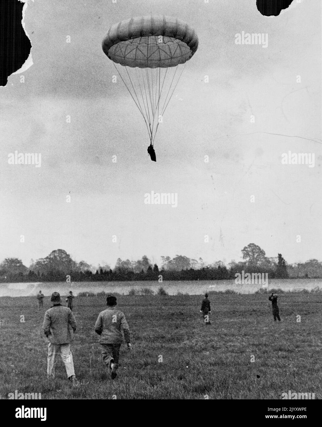 A new Parachute by means of which it is claimed, many lives will ***** saved, is here seen being tested with a dummy at Brooklands. The aeroplane from which it was released was flying at height of only 125 feet, yet the parachute floated its load safely to earth. May 13, 1931. Stock Photo