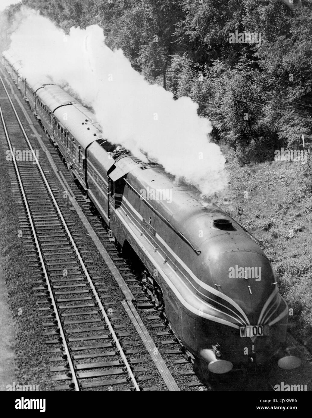 L.M.S.Streamlined Train's Test Run - 'The Coronation Scott' entering the open country at Watford, Hertfordshire, this morning at full speed. The Coronation Soot,' the blue and silver, high-speed, luxury, streamlined express specially' designed and constructed by the London, Midland & Scottish. Railway for the new 6½-hour service between London and Glasgow, was given a test run to-day from Euston Station, London. N.W., to Crewe and black. This test run, the first made toy the train as a complete unit behind one of the five giant streamlined 'Coronation' type locomotives specially built for work Stock Photo