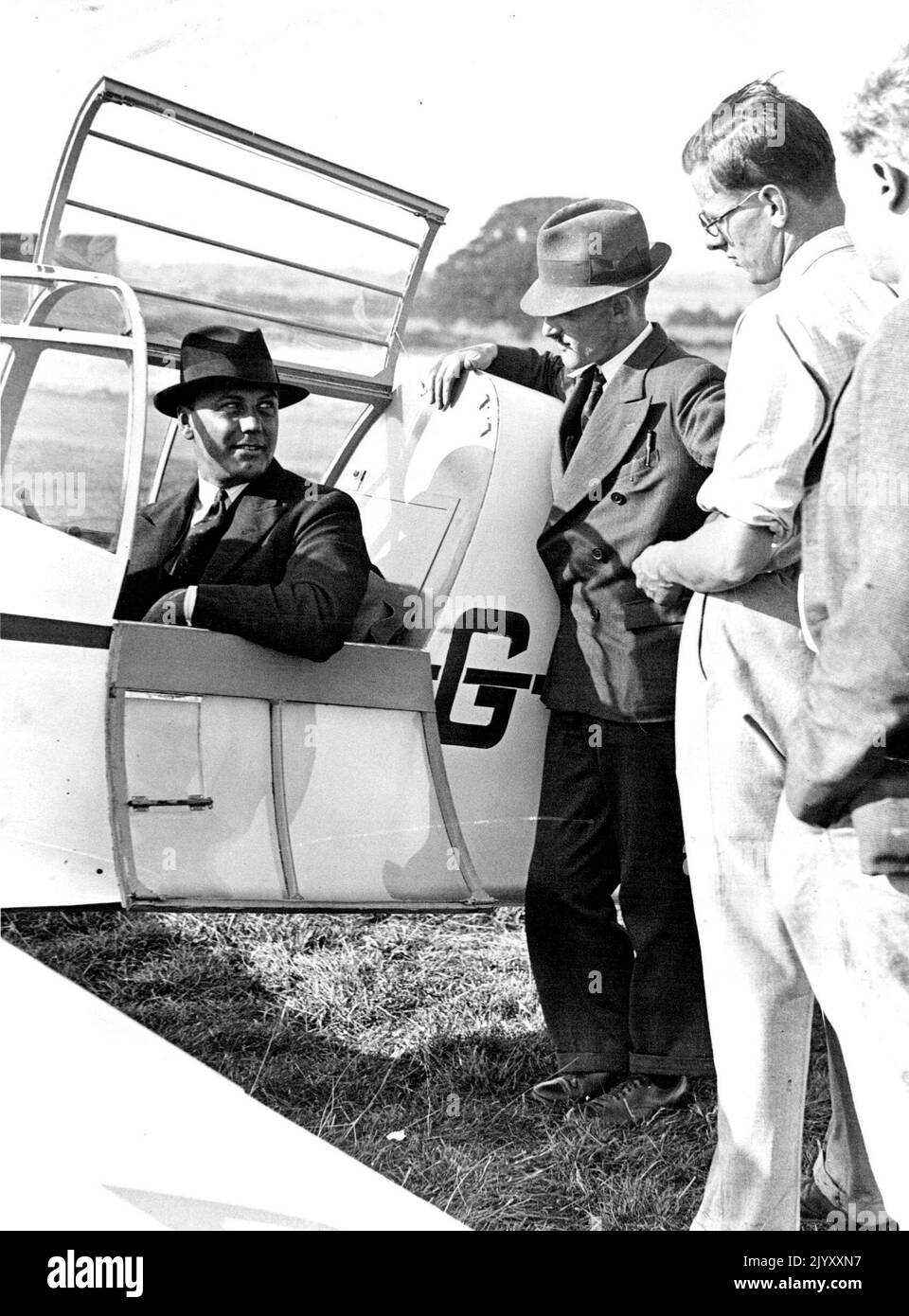 ***** For King's Cup Air Race Percival, who is flying the Viscountess Wakefield of Hythe's 'Percival 'Mew Gull' in the Air Race, talking to advisers about the plane, at Luton Aerodrome. October 18, 1937. (Photo by LNA). Stock Photo