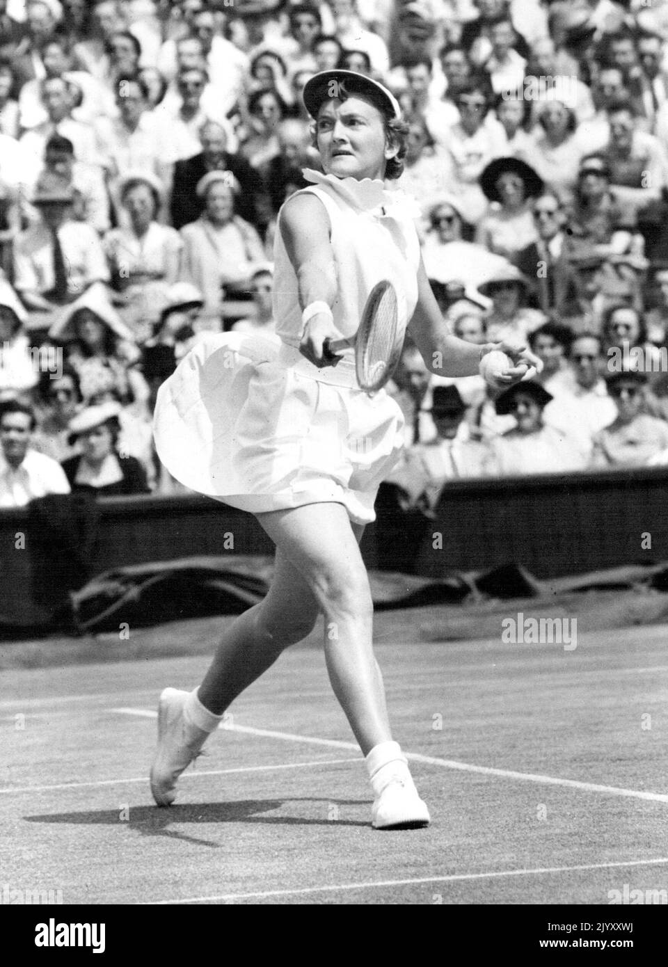 Championship Worries? - Slightly worried expression is worn by Australia's Beryl Penrose, concentrating on her Centre Court battle against wily and dangerous American Louise Brough in the women's singles of the Lawn Tennis Championships at Wimbledon, London, to-day (Friday). June 27, 1952. (Photo by Reuter Photo). Stock Photo