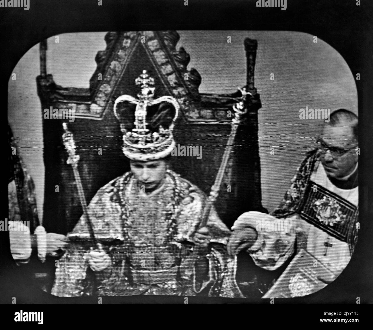 EDITORS PLEASE NOTE THAT THIS IS A SCREEN GRAB File photo dated 02/06/1953 of Queen Elizabeth II wearing St Edward's Crown, at the Coronation ceremony at Westminster Abbey. This was the view as seen by television viewers immediately after the Archbishop of Canterbury, Dr Geoffrey Fisher, had placed the crown upon the Queen's head. The Queen's coronation, rich in religious significance, was a morale boost for a nation starved of pageantry by the war, and for a day street parties banished the hardship of rationing and shortages and even atrocious, unseasonal weather did not dampen the enthusiasm Stock Photo