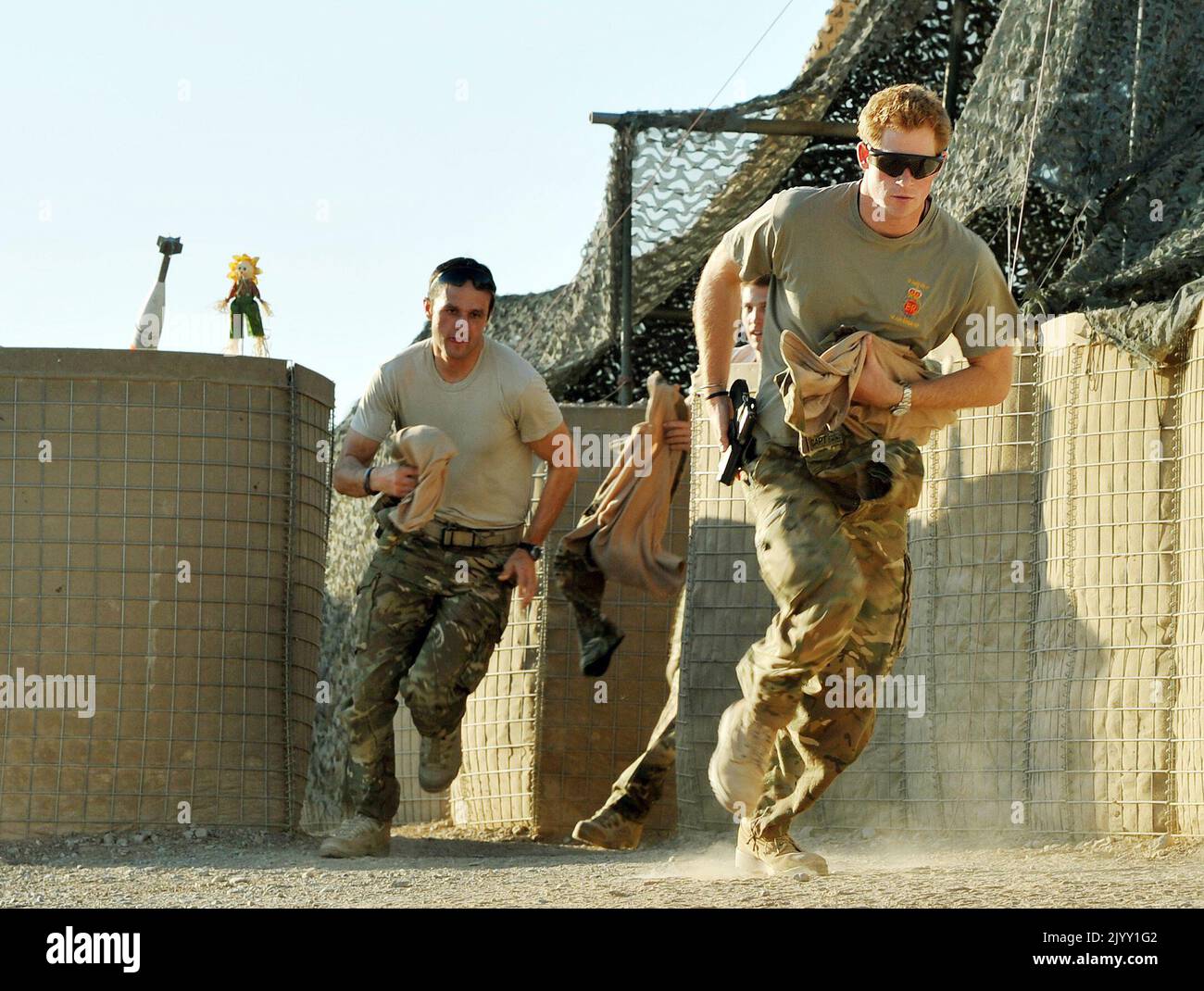 File photo dated 03/11/2012 of Prince Harry (right) or just plain Captain Wales as he was known in the British Army, racing out from the VHR (very high readiness) tent to scramble his Apache with fellow Pilots, during his 12 hour shift at the British controlled flight-line in Camp Bastion southern Afghanistan, where he was serving as an Apache Helicopter Pilot/Gunner with 662 Sqd Army Air Corps, from September 2012 for four months until January 2013. The former soldier said the time he spent in the Army, when he was 'just Harry', was 'the best escape I've ever had' and he had considered giving Stock Photo