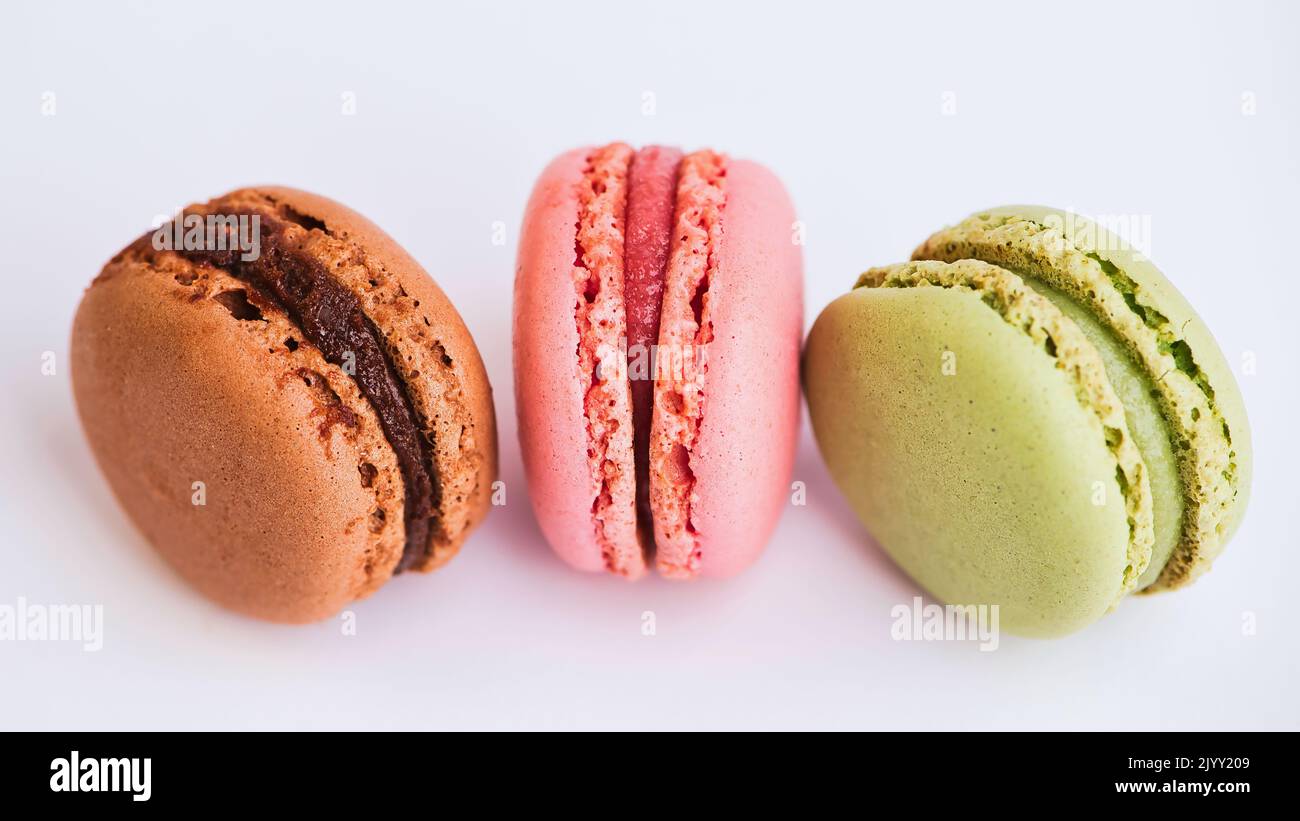 strawberry, chocolate and pistachio macaroon against white background Stock Photo