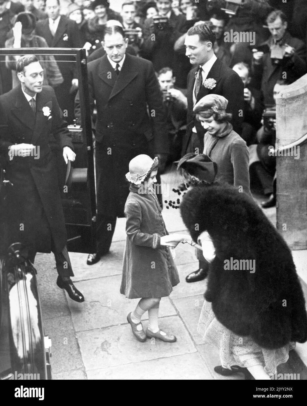 File photo dated March 1939 of Princess Elizabeth (far right) arriving with her father, King George V (stepping from car), and sister, Princess Margaret, for the wedding of the Hon. Cecilia Bowes Lyon, niece of the Queen, to Kenneth Harrington at Holy Trinity in Brompton. The romance of Prince Philip of Greece and Princess Elizabeth sprang out of a summer encounter at the Royal Naval College in Dartmouth in the year of 1939. Philip, who was just 18, was introduced to 13-year-old Elizabeth at the house of the captain of the college, later Admiral Sir Frederick Dalrymple-Hamilton. Issue date: Th Stock Photo
