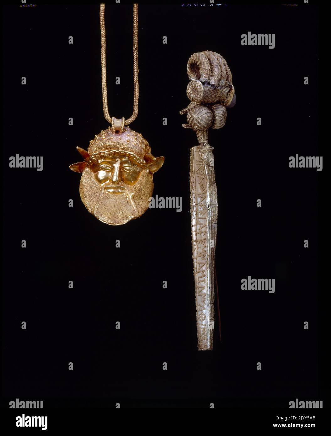 5th century BC Etruscan Gold work: pendant representing Achelous, the Greek River God (left) and a Serpentine fibula (right). The Serpentine bow fibula, known as the Chiusi fibula dates from the 9th-1st centuries BC. The Etruscan civilization is the modern name given to a powerful and wealthy civilization of ancient Italy in the area corresponding roughly to Tuscany, from 700 BC) until its assimilation into the Roman Republic, beginning in the late 4th century BC Stock Photo