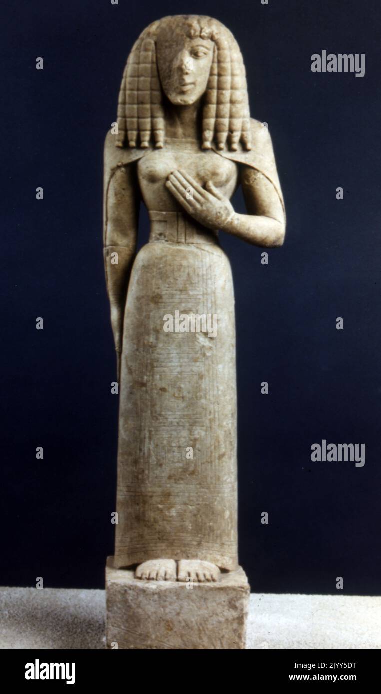limestone Cretan sculpture called the Lady of Auxerre, (or Kore of Auxerre). Depicts an archaic Greek goddess of c. 650 - 625 BC. It is a Kore (maiden), perhaps a votary rather than the maiden Goddess Persephone. The Archaic sculpture, bearing traces of polychrome decoration, dates from the 7th century BCE, when Greece was emerging from its Dark Age. She still has the narrow waist of a Minoan-Mycenaean goddess, and her stiff hair suggests Egyptian influence. Stock Photo