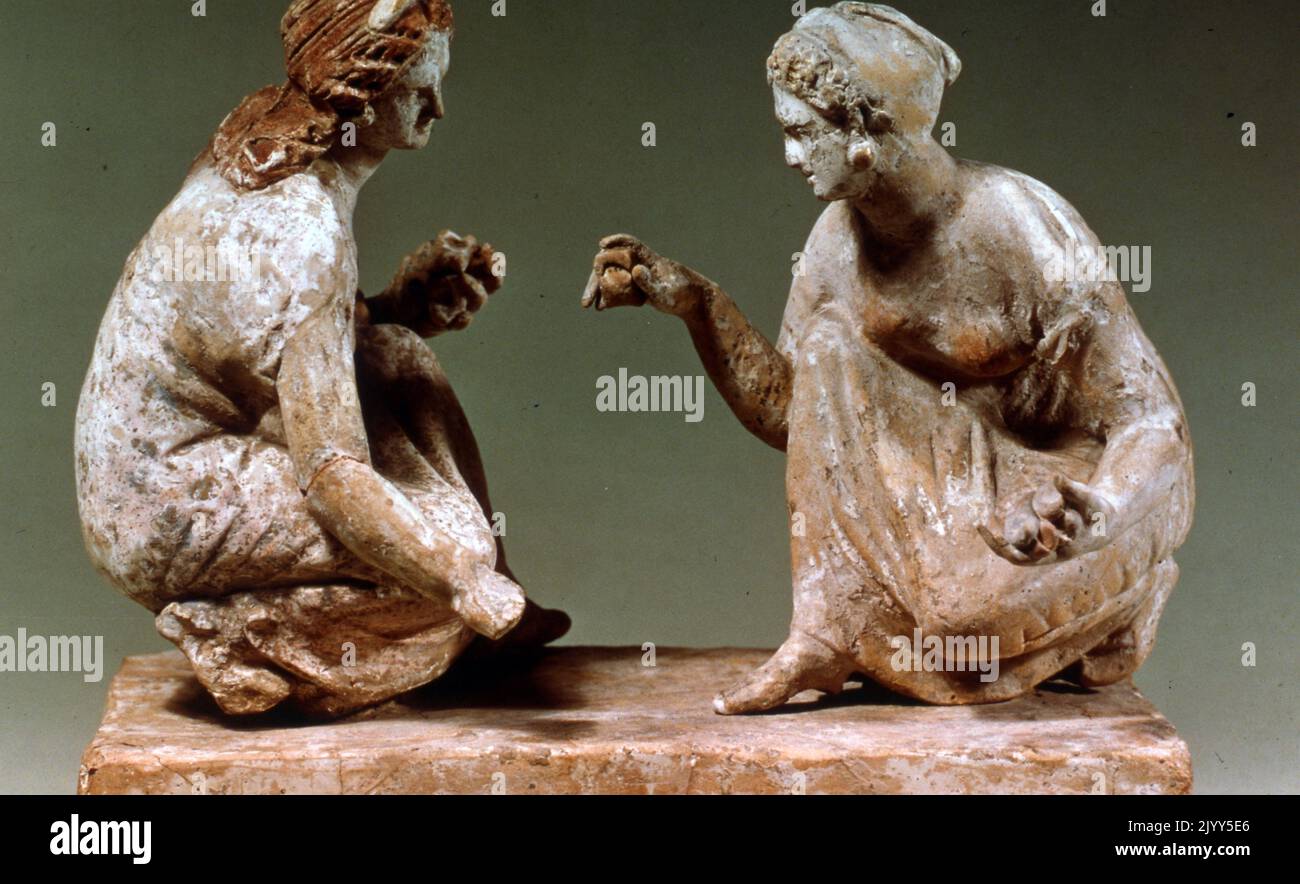 Greek influenced, painted terracotta statuette of two women playing knucklebones. Campanian, 330BC-300BC, Italy, Campania. Stock Photo