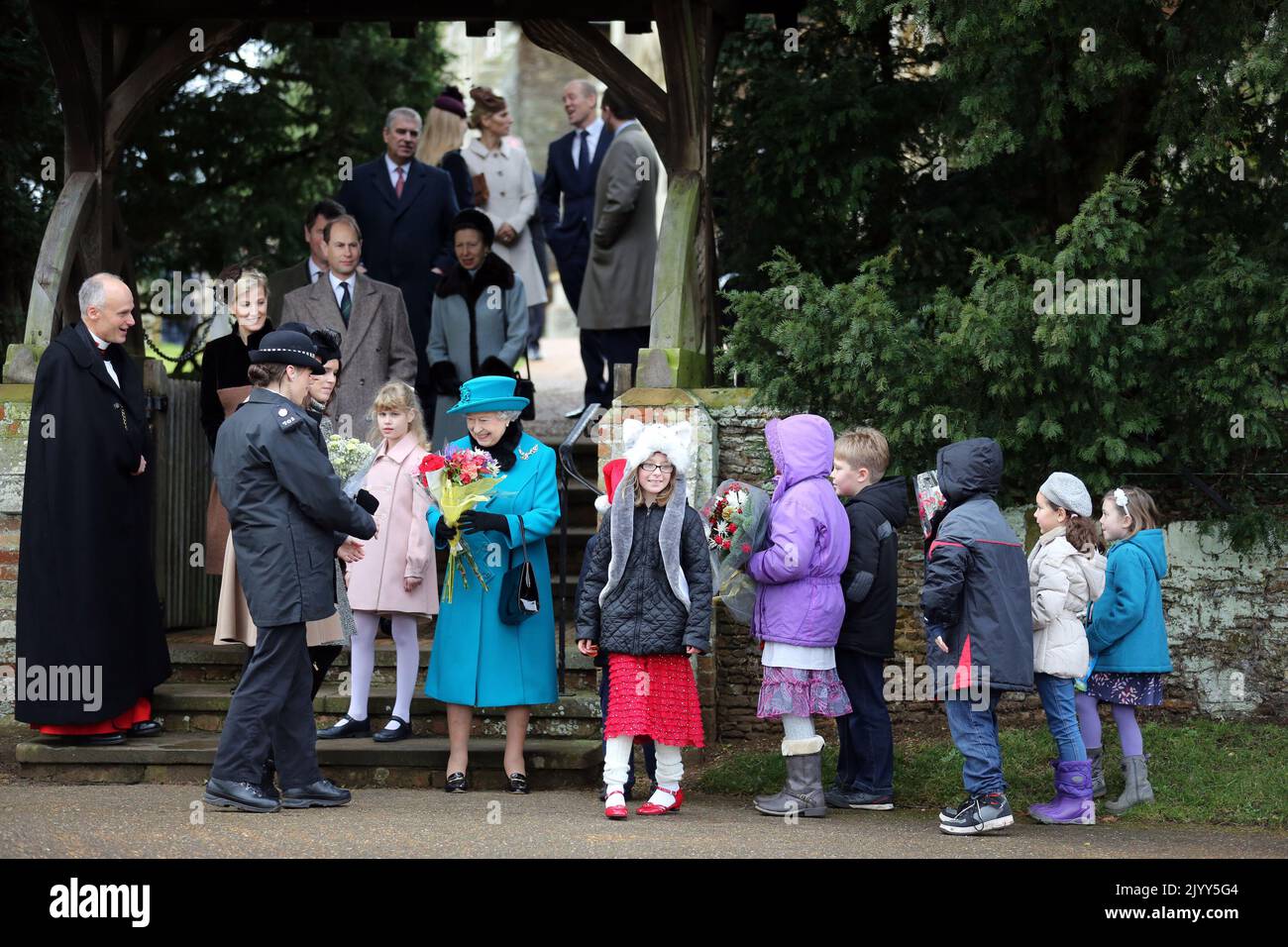 File photo dated 25/12/2012 of Queen Elizabeth II receiving flowers from children after she attended St Mary Magdalene Church, on the royal estate in Sandringham, Norfolk for the traditional Christmas Day church service. Issue date: Thursday September 8, 2022. Stock Photo