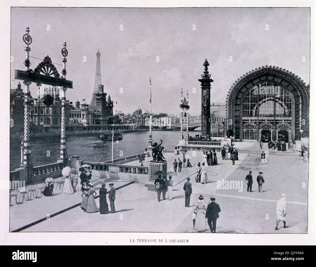 Exposition Universelle (World Fair) Paris, 1900; The Exposition Universelle of 1900, better known in English as the 1900 Paris Exposition, was a world's fair held in Paris, France, from 14 April to 12 November 1900, to celebrate the achievements of the past century and to accelerate development into the next. The style that was universally present in the Exposition was Art Nouveau. The fair, visited by nearly 50 million, displayed many technological innovations; black and white photograph of the terrace of the aquarium. Stock Photo