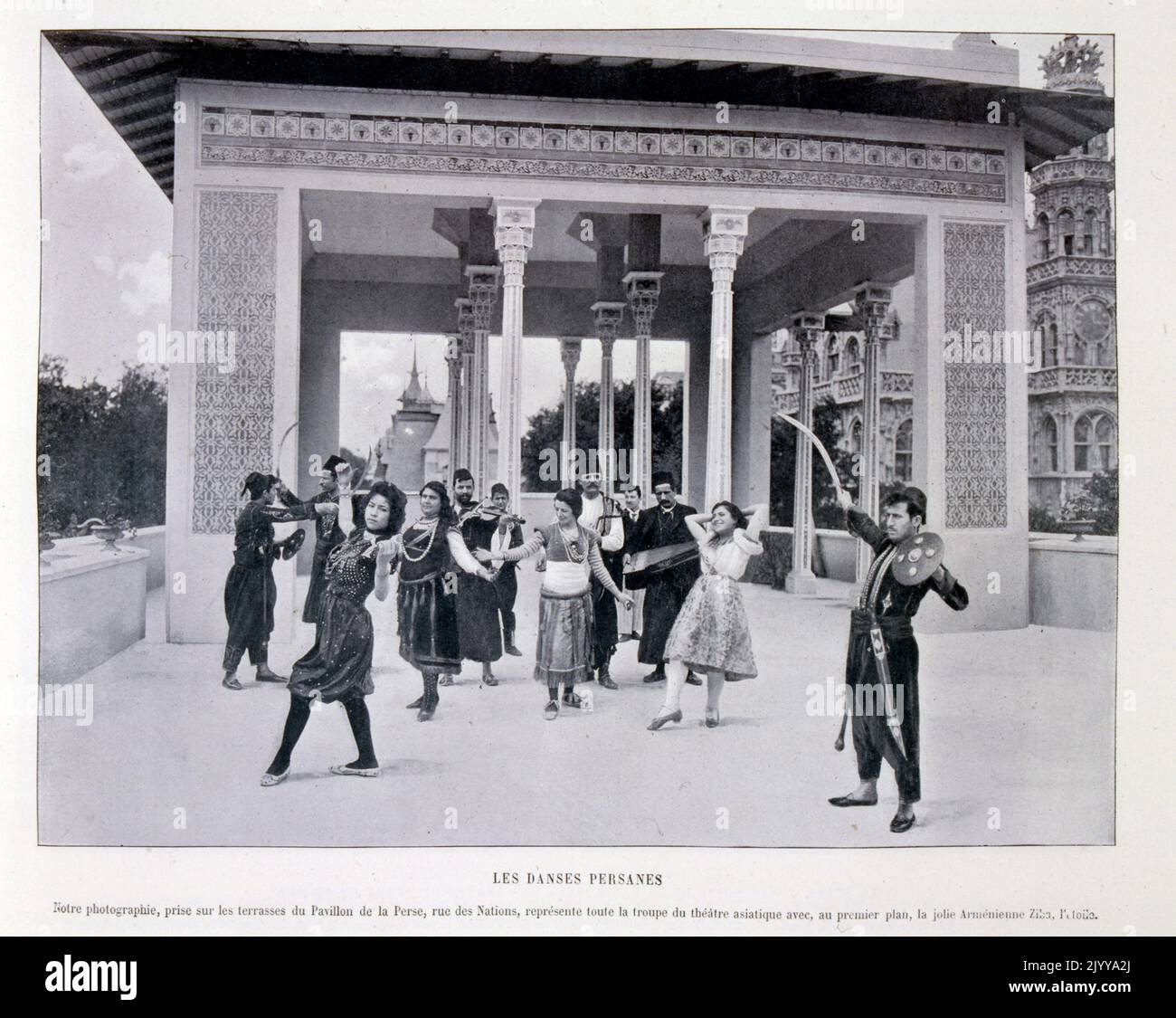 Exposition Universelle (World Fair) Paris, 1900; The Exposition Universelle of 1900, better known in English as the 1900 Paris Exposition, was a world's fair held in Paris, France, from 14 April to 12 November 1900, to celebrate the achievements of the past century and to accelerate development into the next. The style that was universally present in the Exposition was Art Nouveau. The fair, visited by nearly 50 million, displayed many technological innovations; black and white photograph of Persian dancers on the terrace on the Rue des Nations. Stock Photo