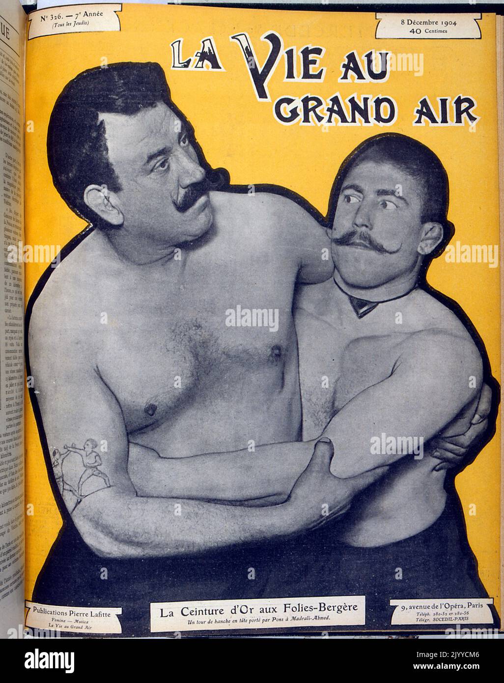 Photograph inside of the lifestyle magazine La Vie au Grand Air; two men wrestling. Stock Photo