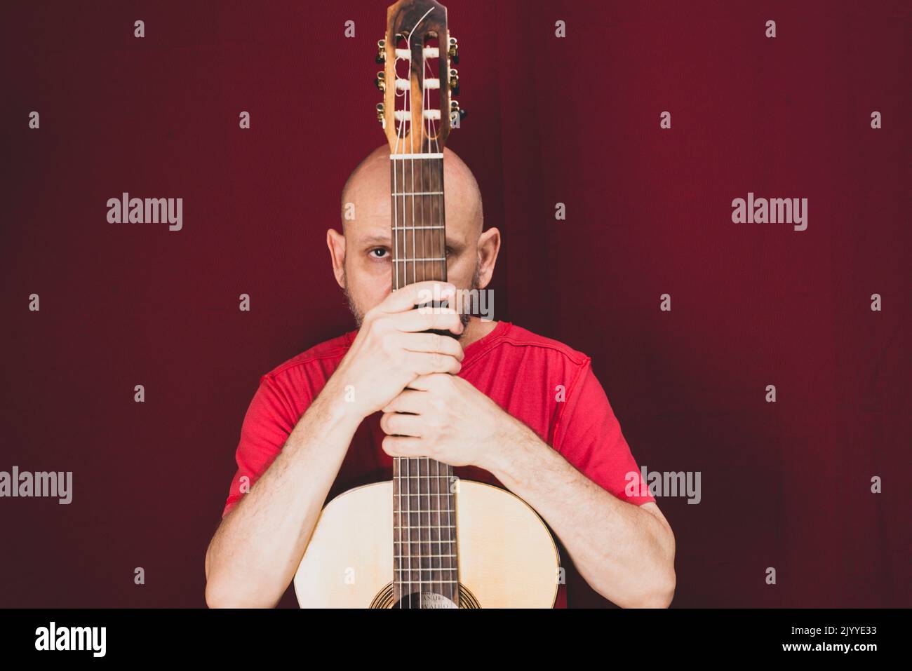 String musical instrument. Mature charismatic male guitarist. guy with