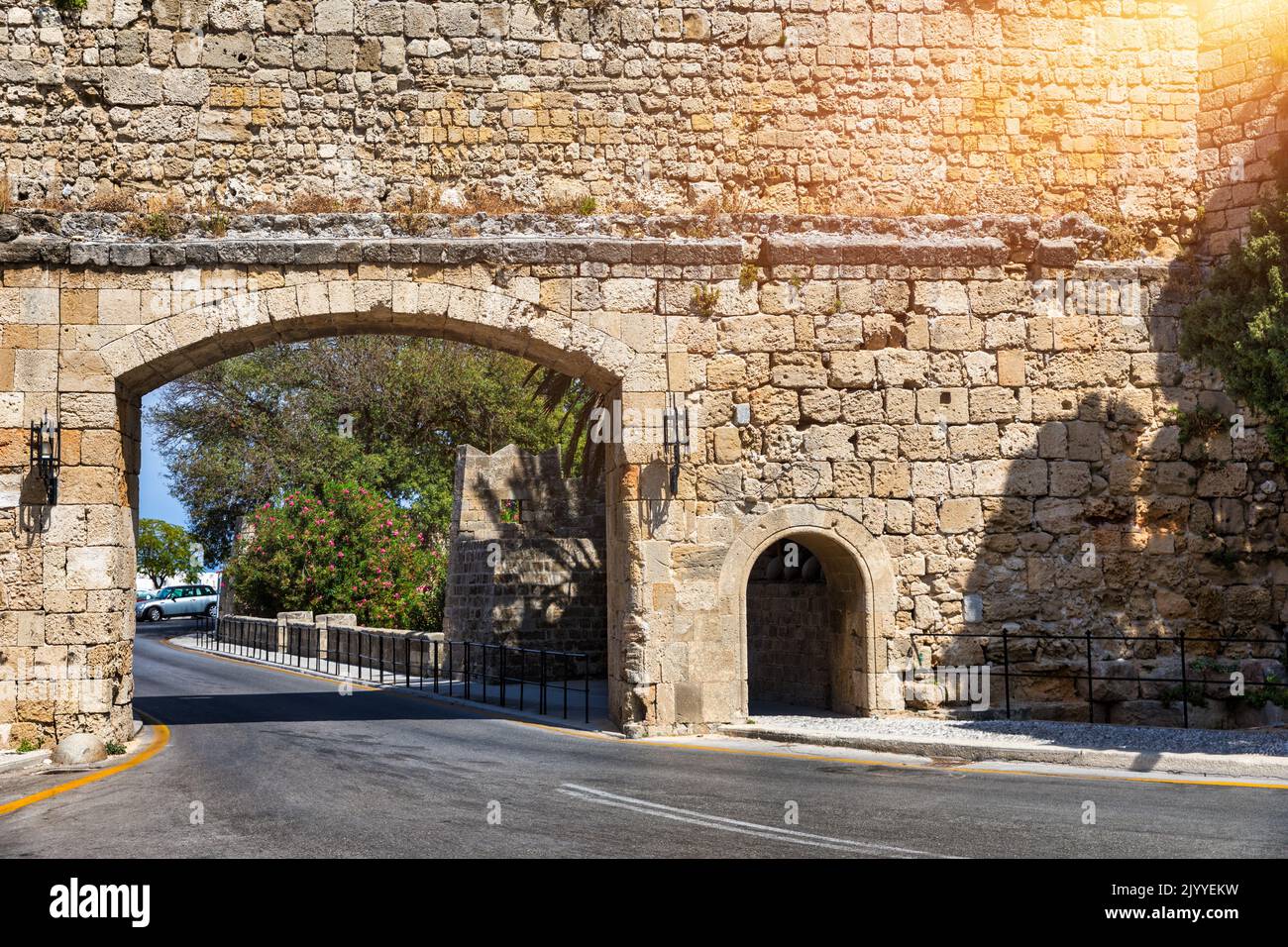 Medieval arched street in the old town of Rhodes, Greece. Rhodes old town in Rhodes island in Greece. Historical streets of old town Rhodes with flowe Stock Photo