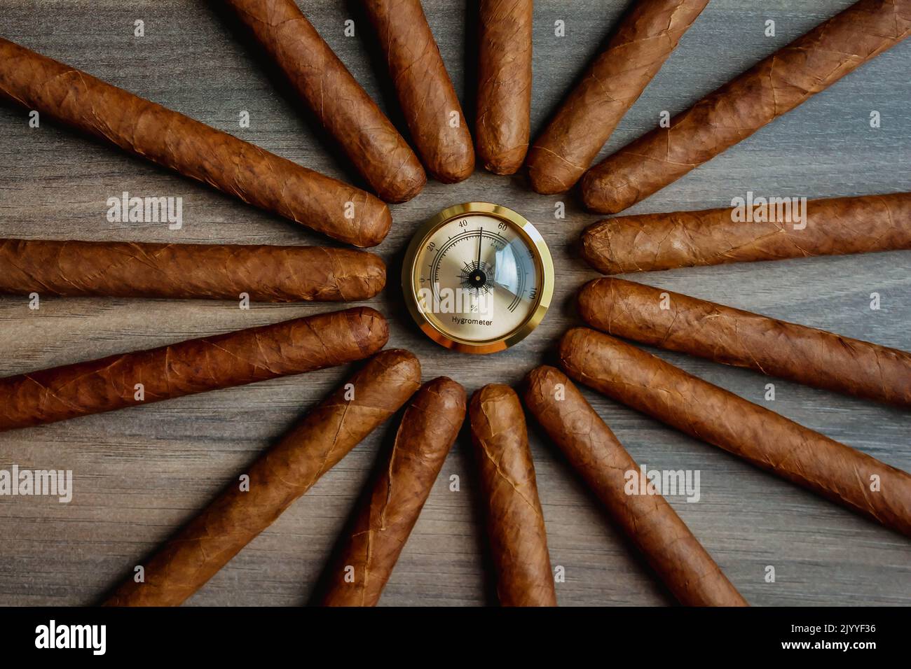 Pile of cigars with humidor hygrometer on the wooden background Stock Photo