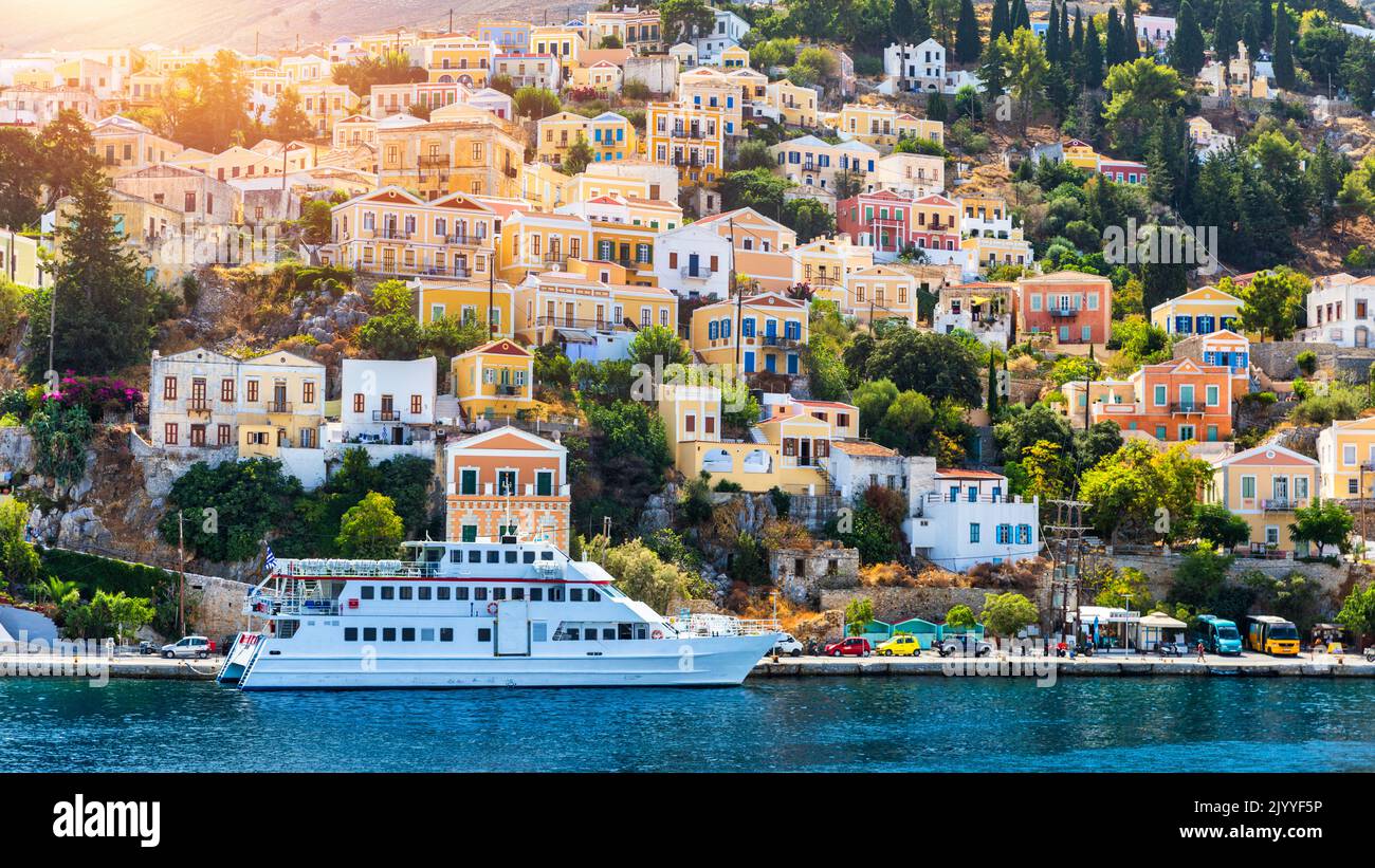 View of the beautiful greek island of Symi (Simi) with colourful houses and small boats. Greece, Symi island, view of the town of Symi (near Rhodes), Stock Photo