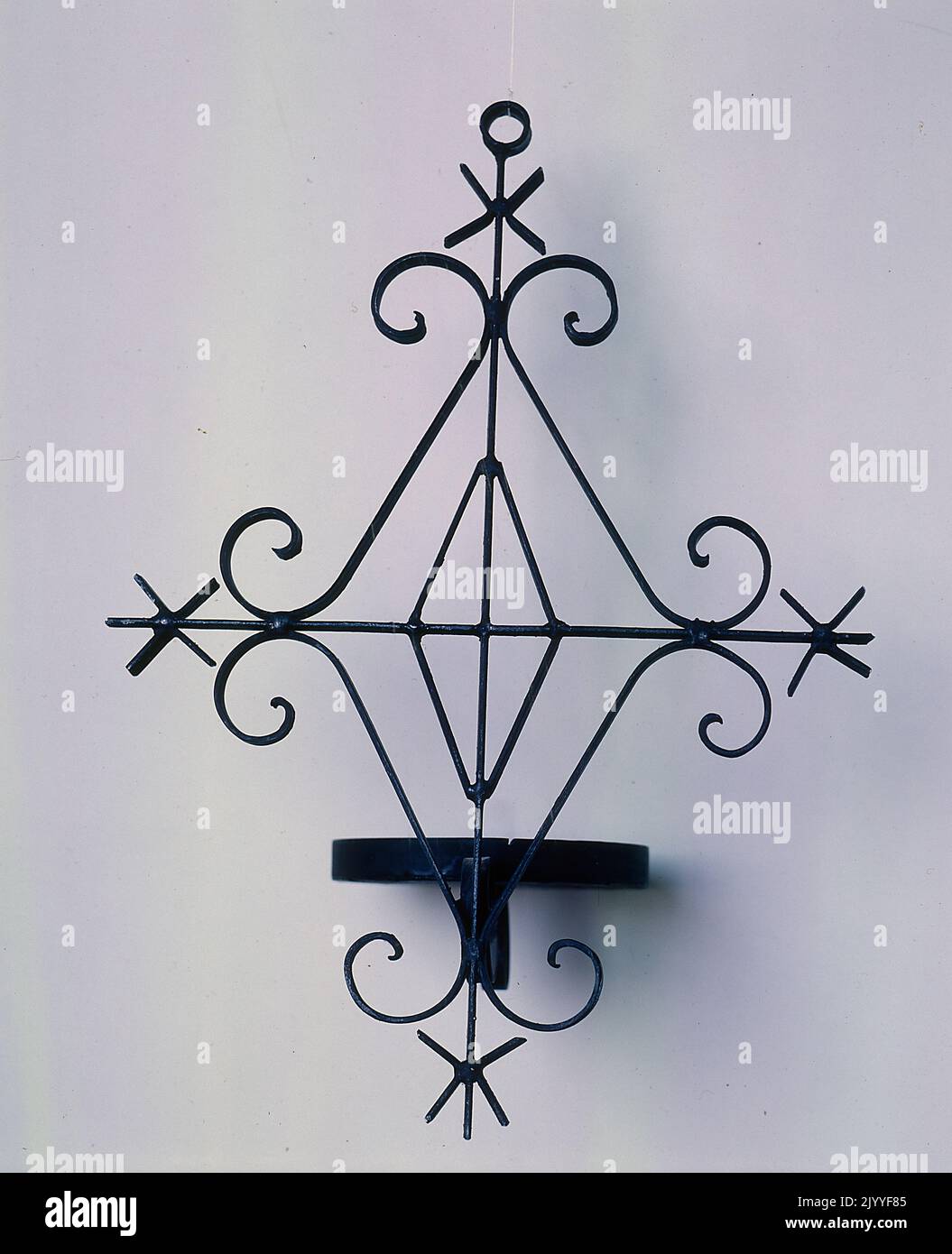 Colour photograph of a 3D diamondshaped iron decorative piece Stock