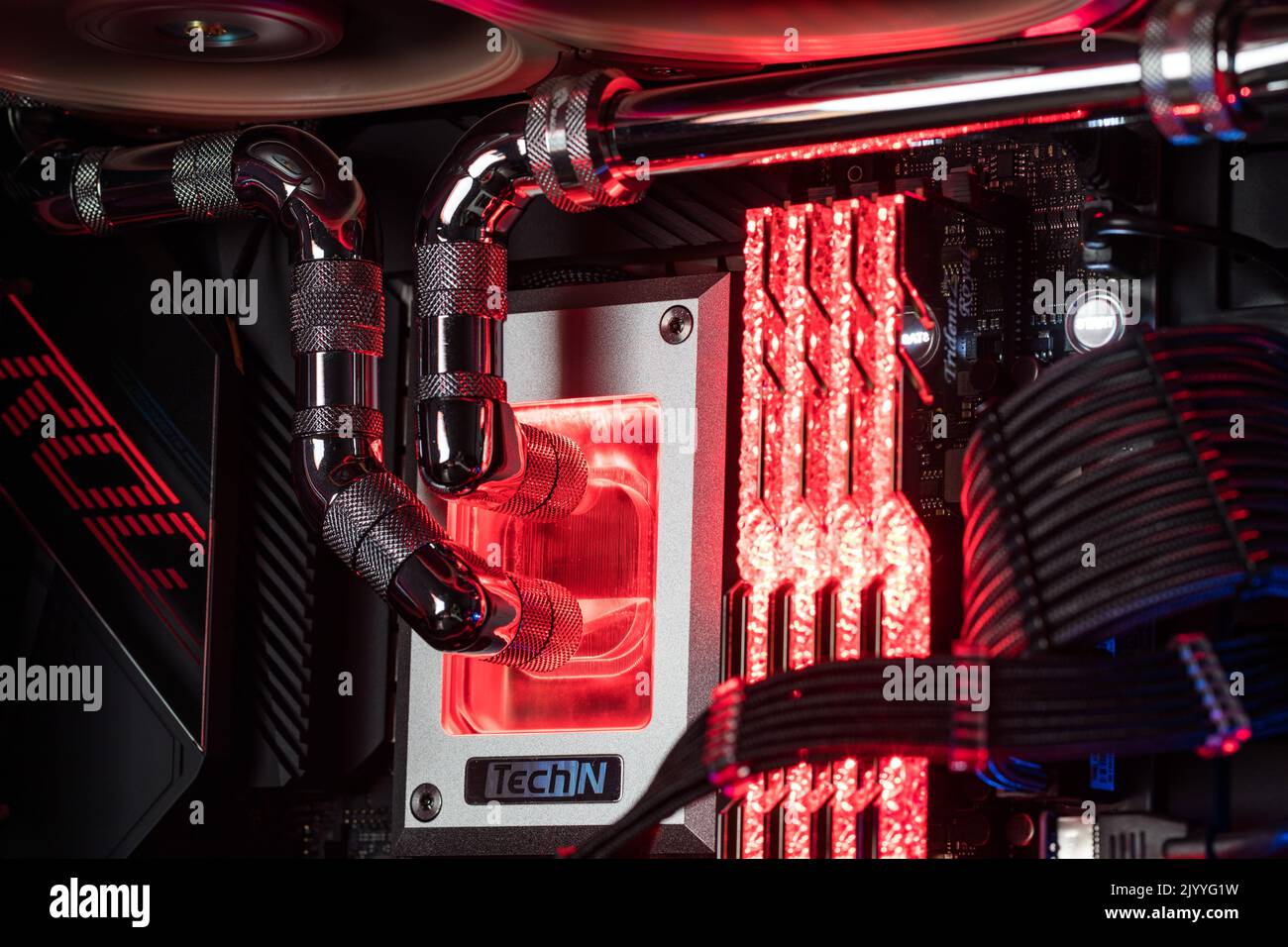 Prague, Czech Republic - 21 July 2021: Close-up of high performance Desktop PC and water cooling system with multicolored LED RGB light show status on Stock Photo