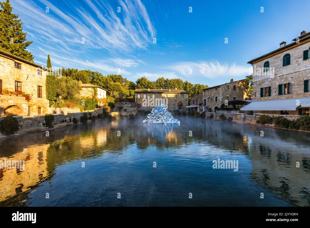 Thermal bath town of Bagno Vignoni, Italy during sunrise. Old thermal baths in the medieval village Bagno Vignoni, Tuscany, Italy. Medieval thermal ba Stock Photo