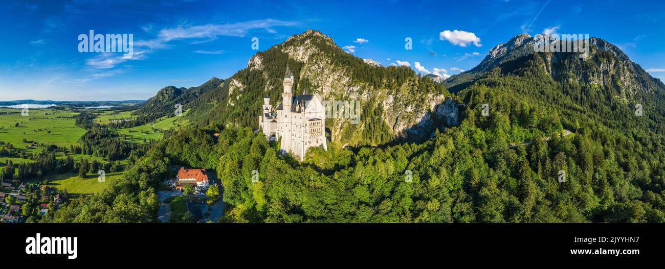 Famous Neuschwanstein Castle with scenic mountain landscape near Fussen, Bavaria, Germany. Neuschwanstein Castle in Hohenschwangau, Germany. Stock Photo
