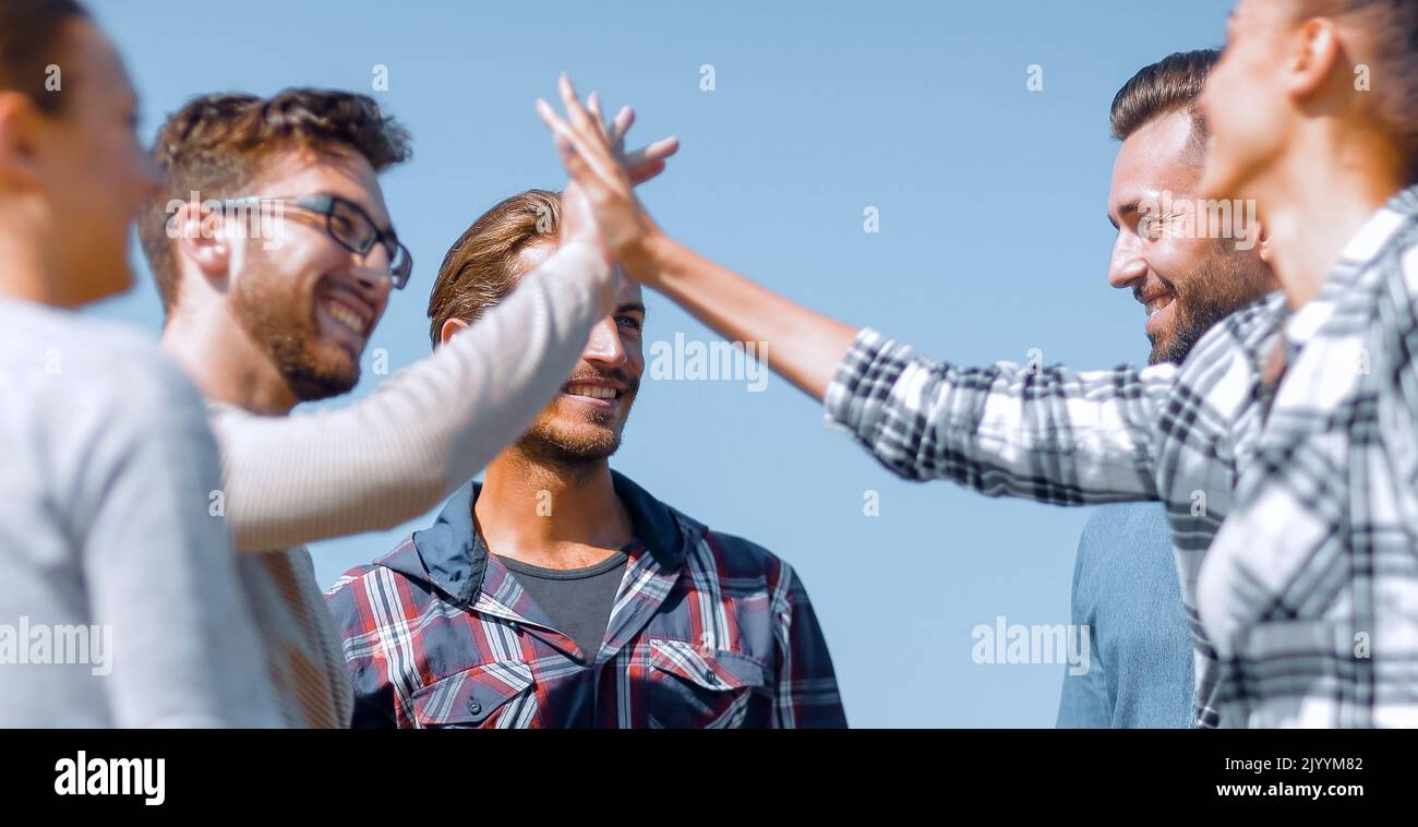 friends greet each other, giving a high five Stock Photo - Alamy