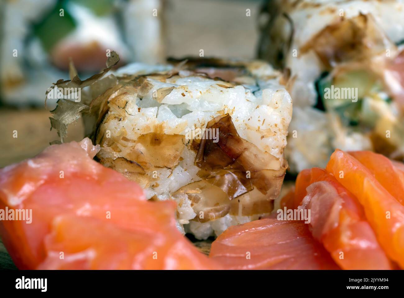 sushi with red salted fish and rice, Asian cuisine sushi of red raw fish with rice and other ingredients Stock Photo