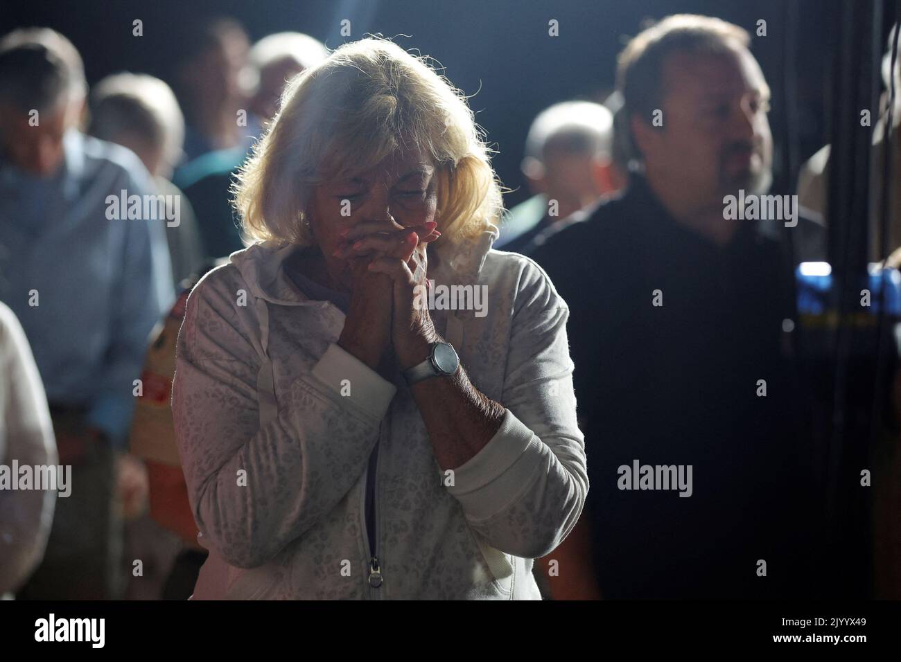 An audience member prays before a Get Out the Vote Rally with Republican candidate for the U.S. House of Representatives Karoline Leavitt and U.S. Senator Ted Cruz (R-TX), in Londonderry, New Hampshire, U.S., September 8, 2022. REUTERS/Brian Snyder Stock Photo