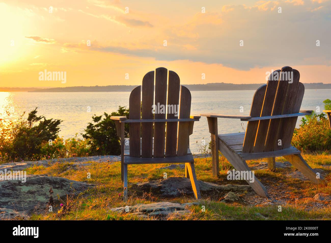 Romantic golden hour seascape as the sun sets and glimmers on the water of Narragansett Bay, Newport, Rhode Island scenic travel landscape Stock Photo