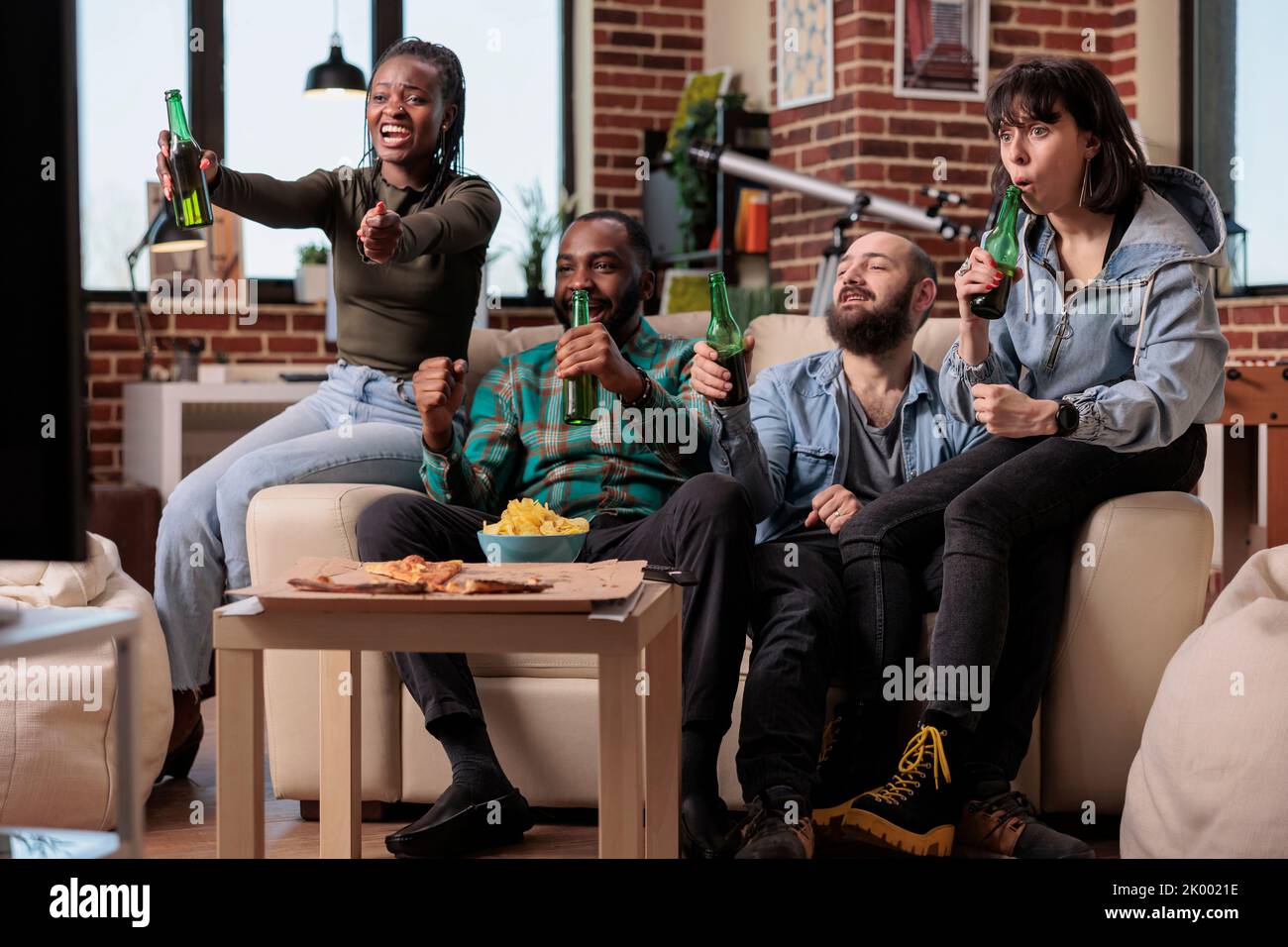 Happy friends watching football game tournament on sport tv channel