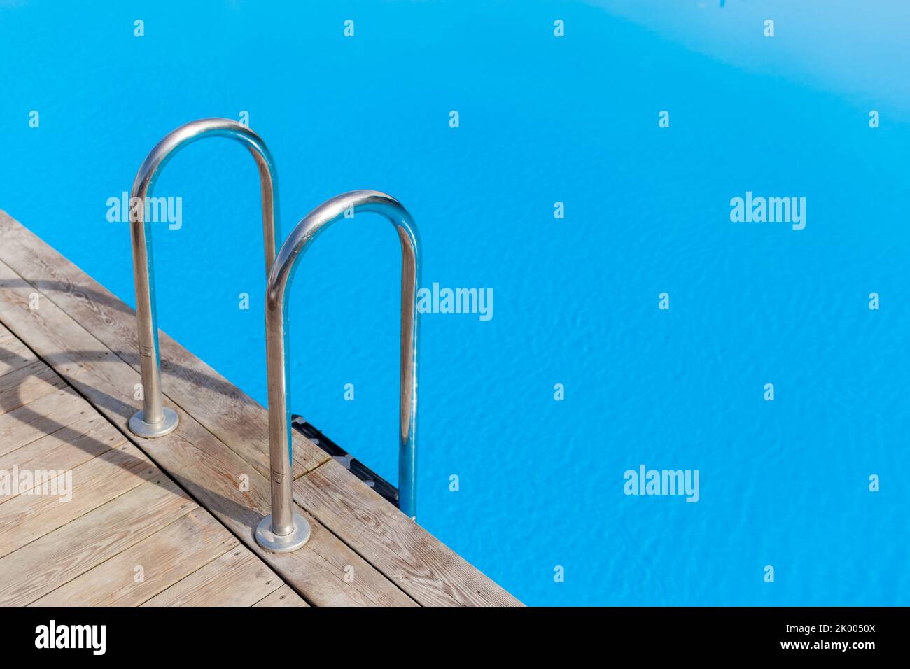 Ladder stainless handrails for descent into swimming pool. Swimming