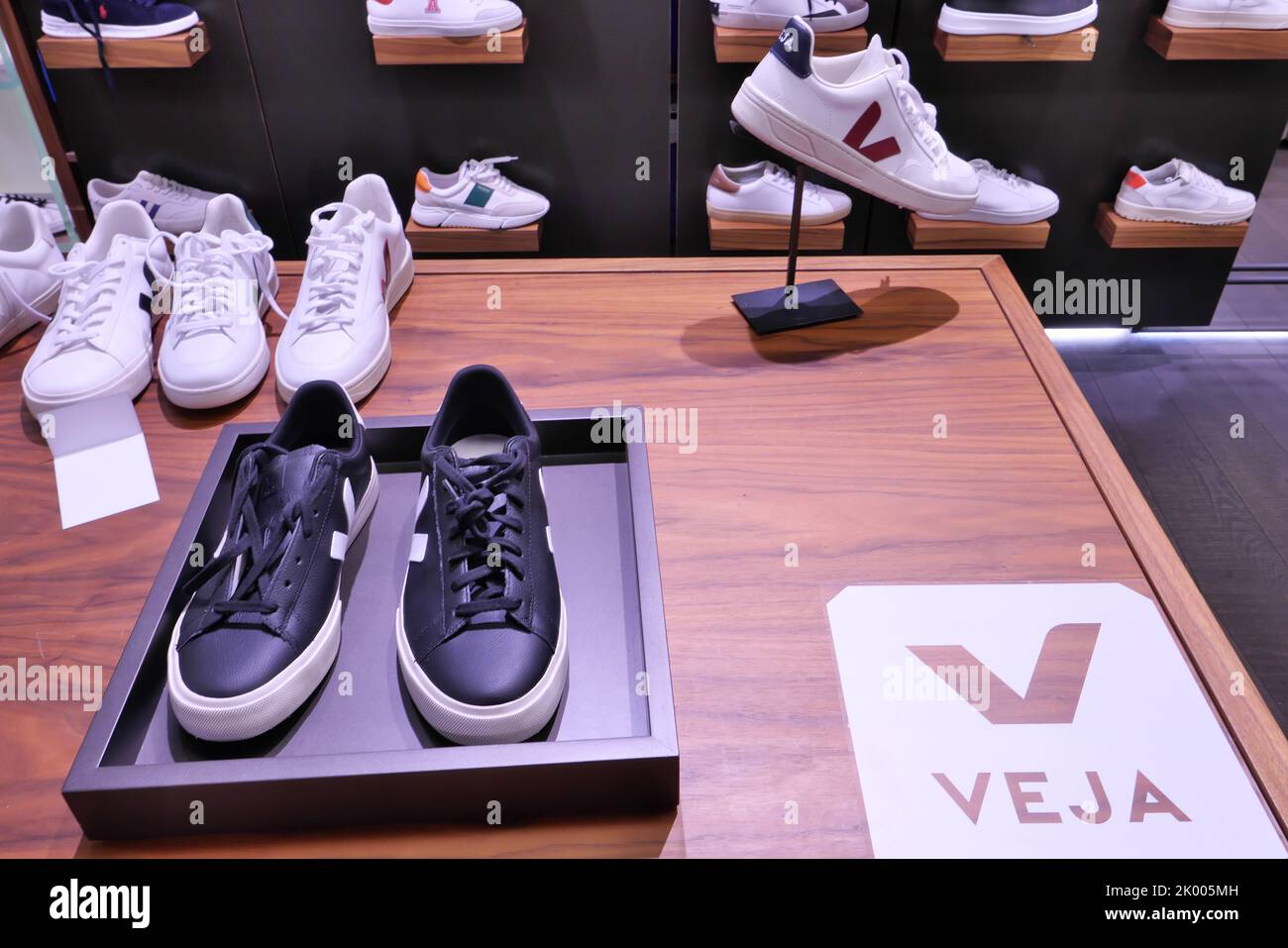 VEJA SHOES ON DISPLAY INSIDE A FASHION STRORE Stock Photo