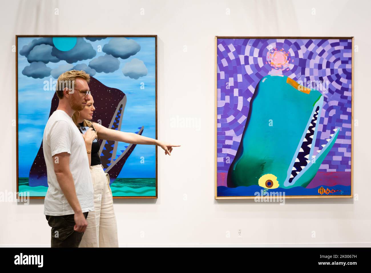 New York, NY, USA. 8th Sep, 2022. The Armory Show opened its VIP Preview at the Javits Center, with galleries worldwide showing modern and contemporary art. Visitors look at whimsical whales by painter Craig Kucia in The Pit gallery booth. Credit: Ed Lefkowicz/Alamy Live News Stock Photo