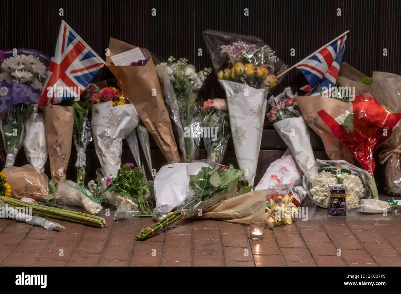 NEW YORK, NEW YORK - SEPTEMBER 08: Floral tributes, candles and British flags for Her Majesty Queen Elizabeth II are seen outside of The British Consulate General in New York on September 8, 2022 in New York City. According to a statement issued by Buckingham Palace on 08 September 2022, Britain's Queen Elizabeth II has died at her Scottish estate, Balmoral Castle, on 08 September 2022. The 96-year-old Queen was the longest-reigning monarch in British history. Stock Photo