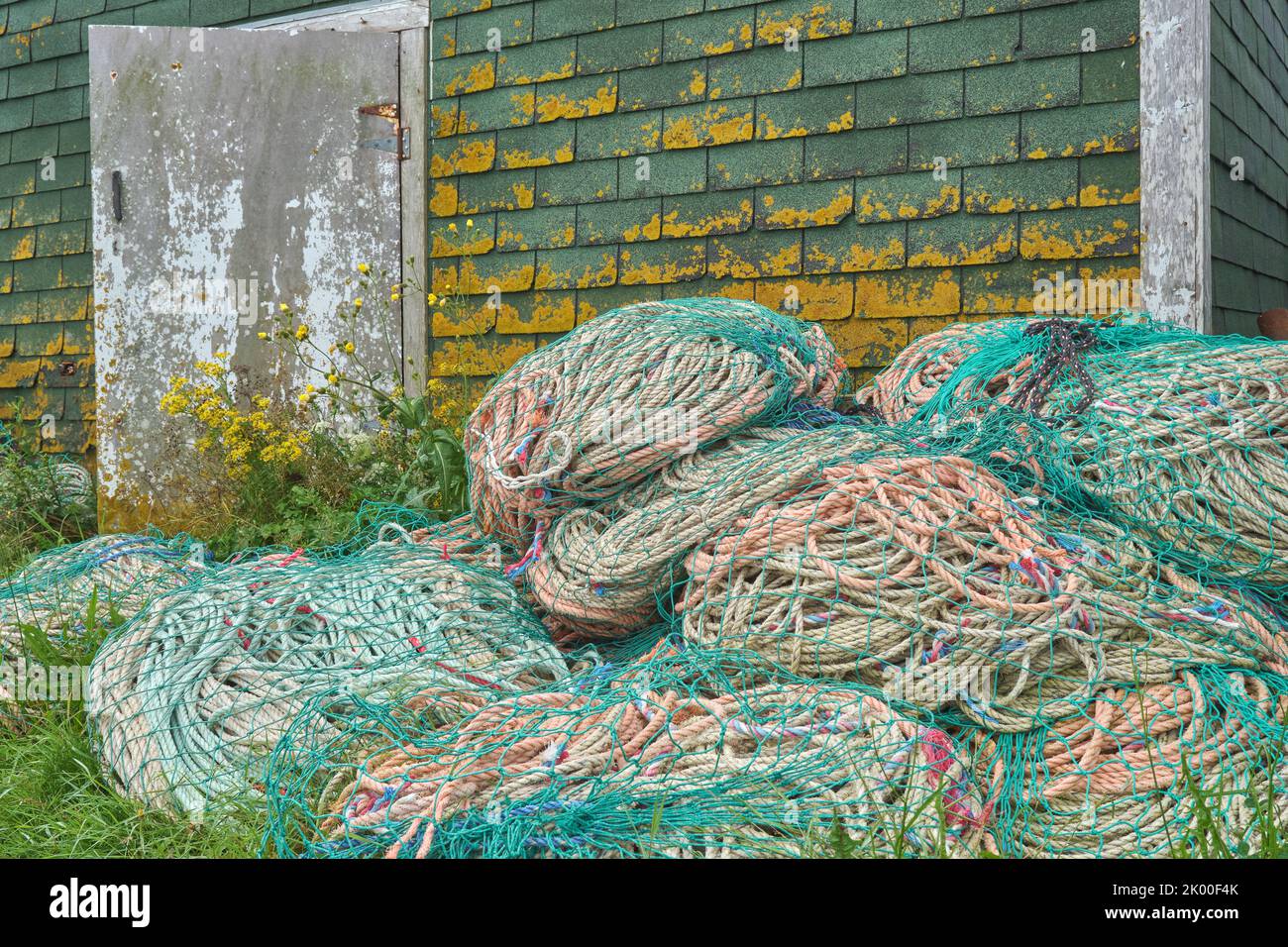 Coils of rope used in the lobster fishing industry piles outside of a fish hut in Sandford Wharf Nova Scotia. Stock Photo