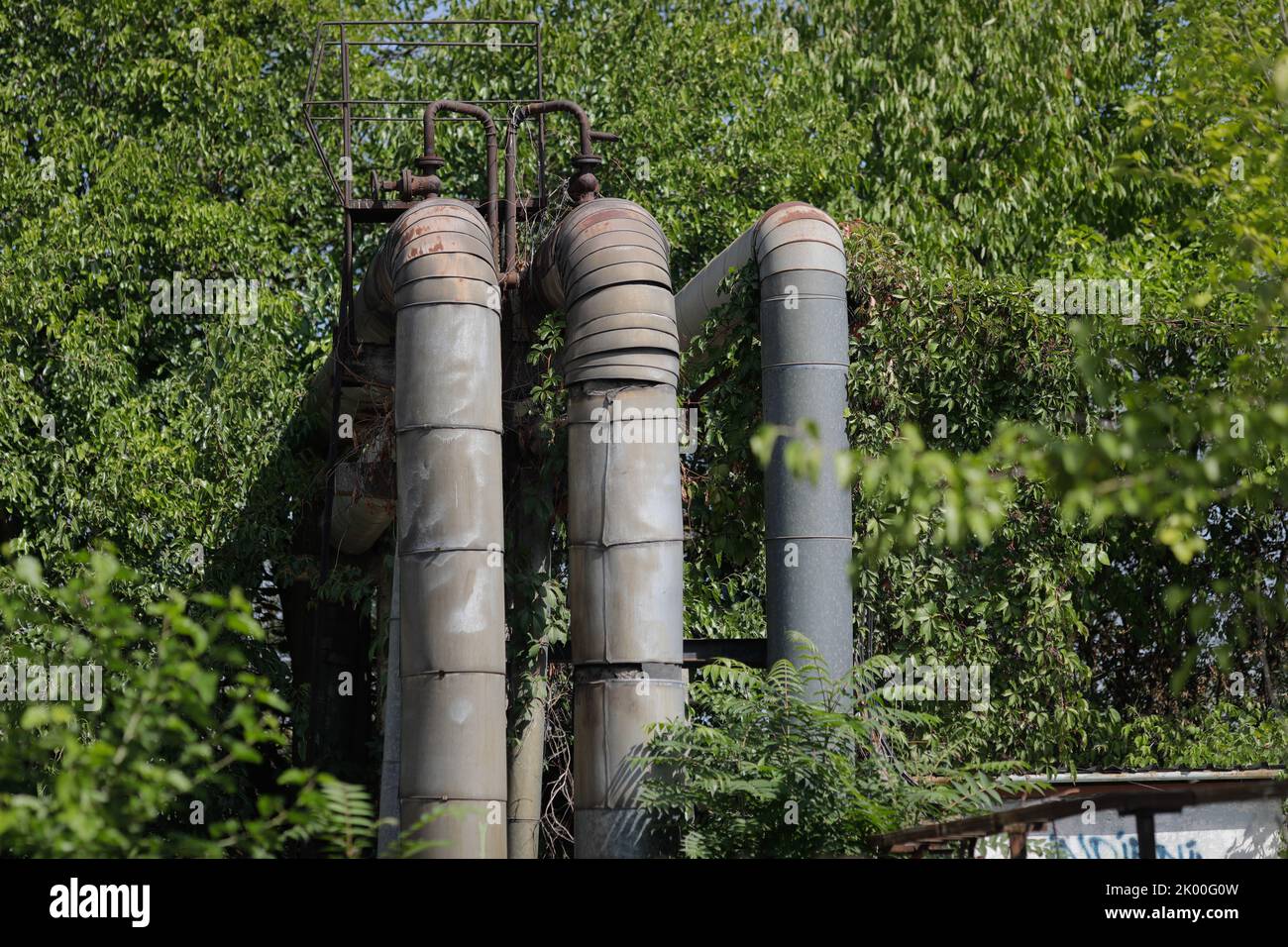 Details with old and rusty pipelines at a Romanian abandoned power plant. Stock Photo