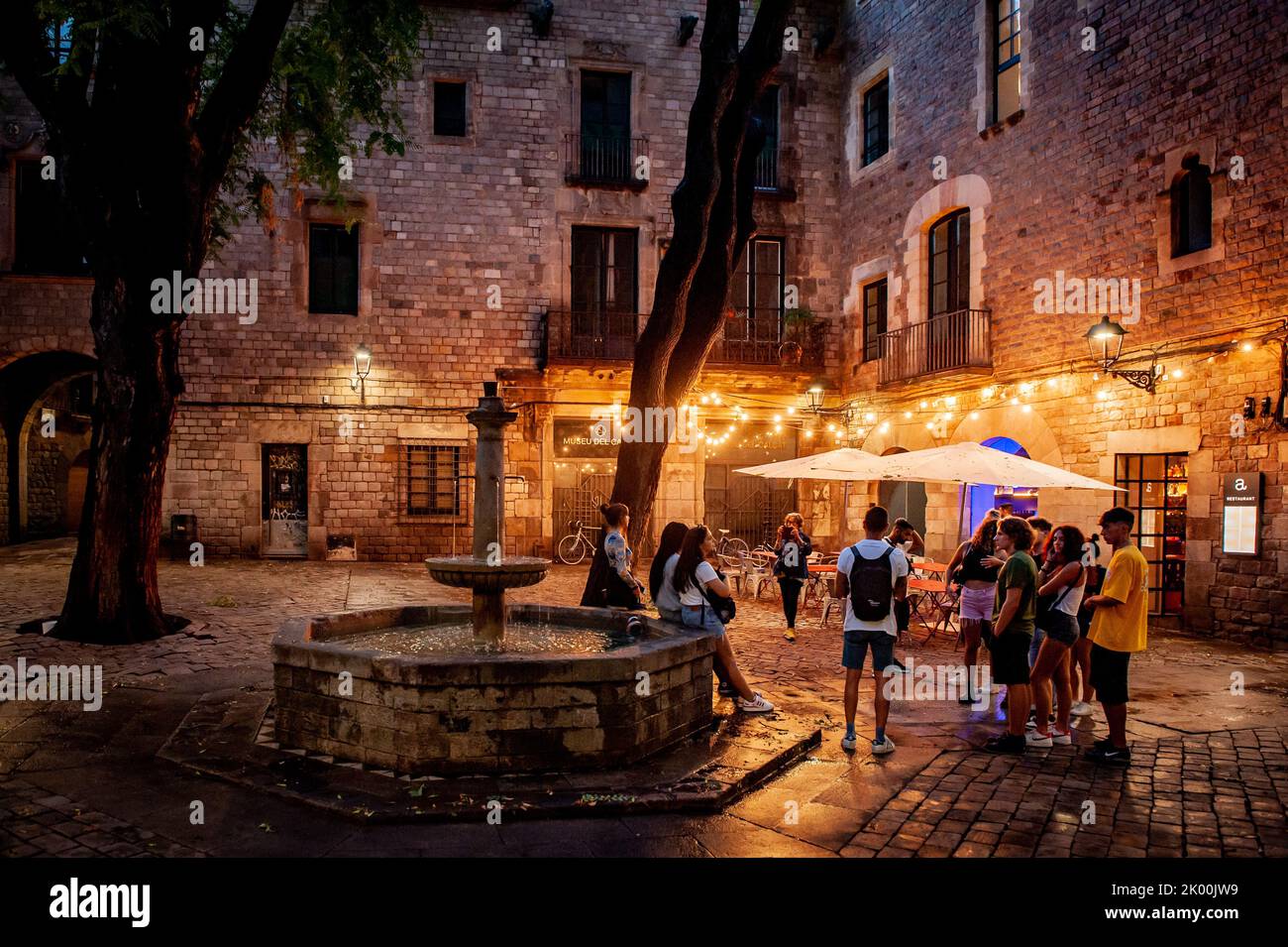 A group of tourists visit Sant Felip Neri square in Barcelona's Gothic Quarter. Stock Photo
