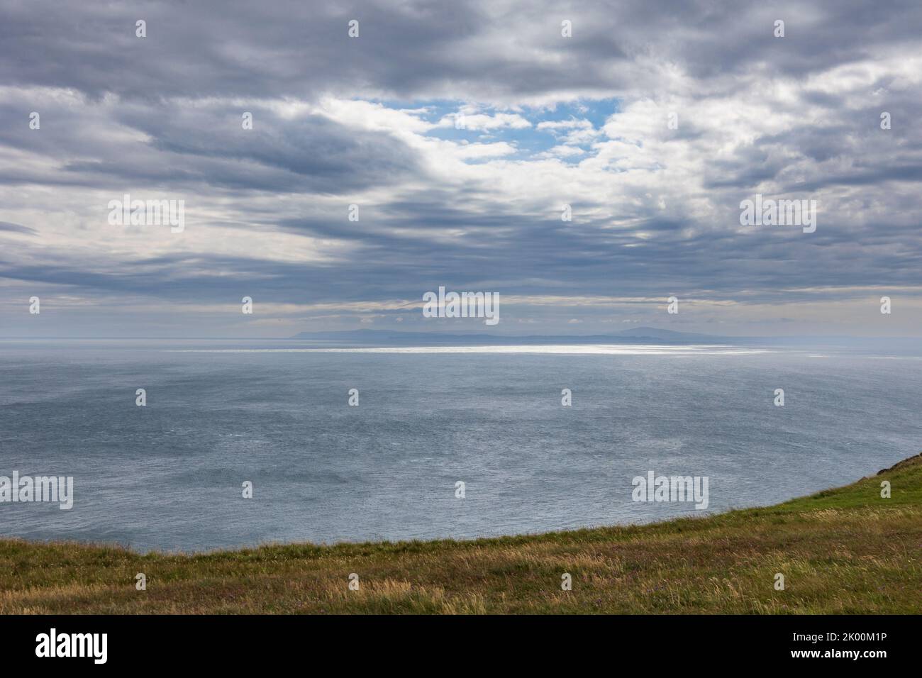 A dramatic sky and distant views of Nortern Island from the Mull of Oa on the south of Islay, a Scottish island Stock Photo