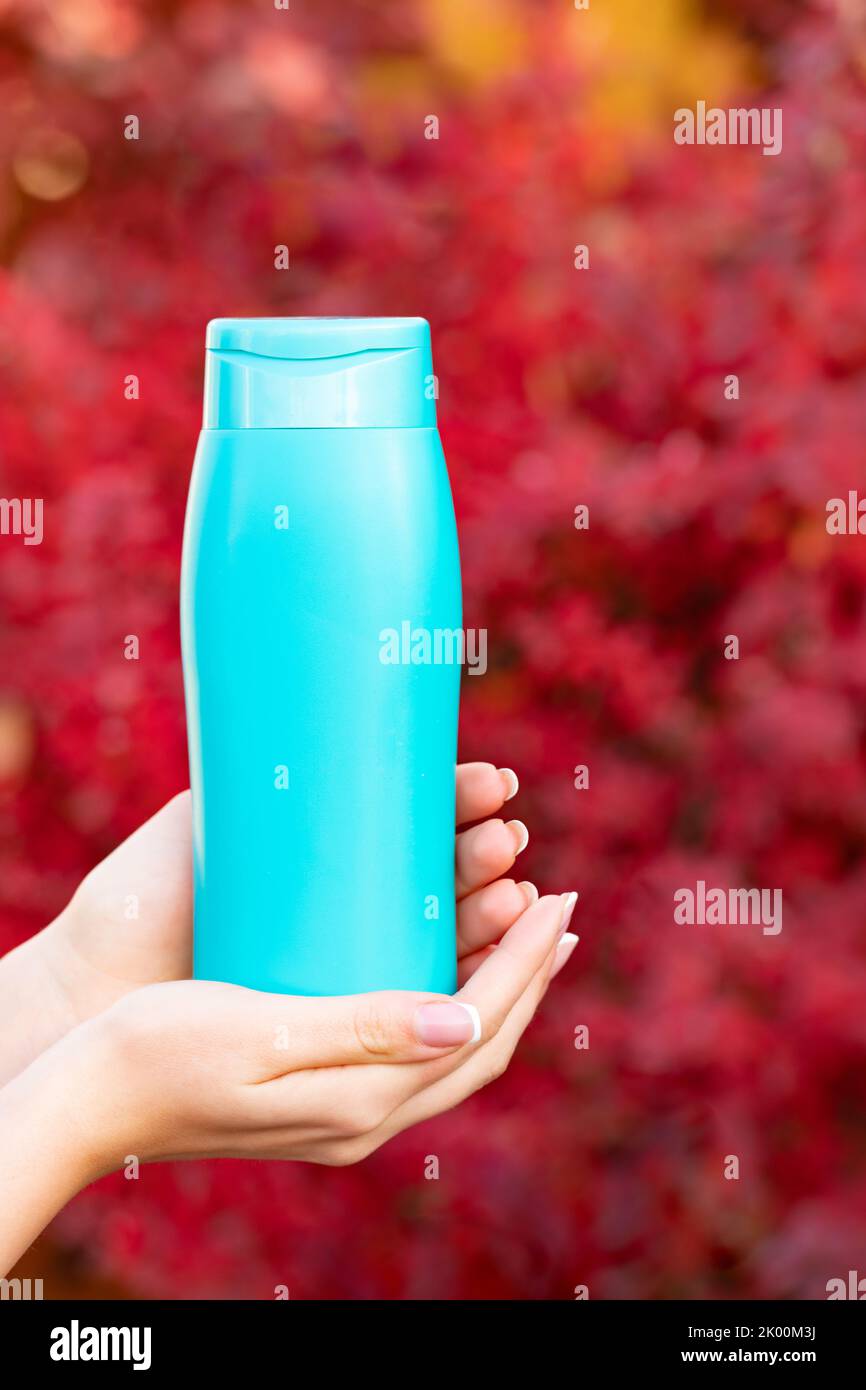 Blue shampoo bottle with combs, slices of citrus fruits, ice cubes and  exotic leaves on a yellow background with copy space. Hair care cosmetics  with Stock Photo - Alamy