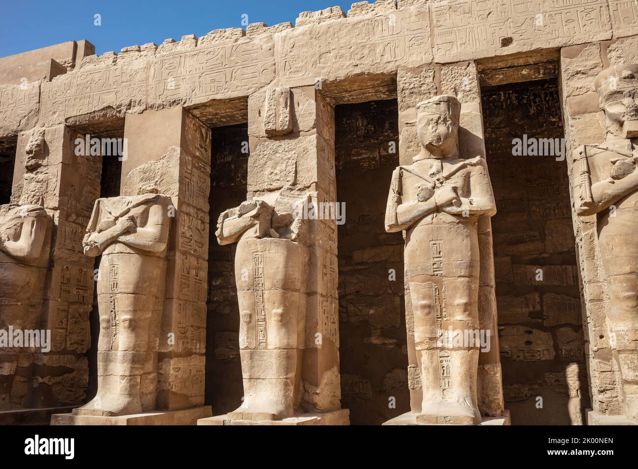 Statues of ancient Egyptian pharaohs and gods. Various hieroglyphs on ...