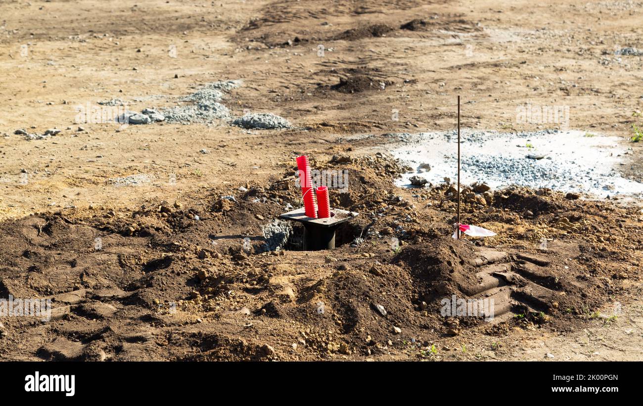 A red plastic pipe sticking out ground is an irrigation system Stock Photo Alamy