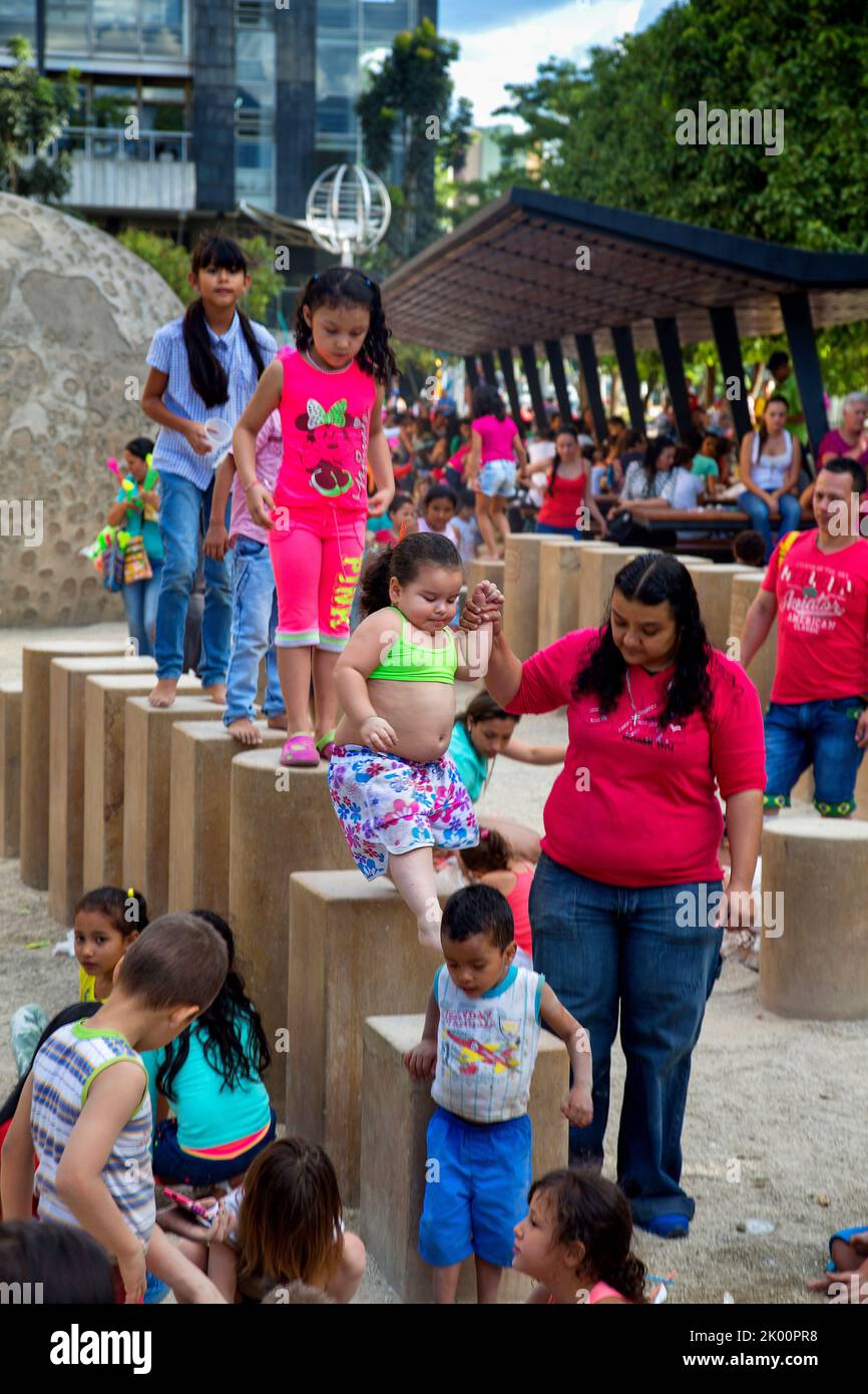 Colombia,Medellin, near Universidad metro station people can relax on the square next to Explora Parque with activities for children lwith sand and wa Stock Photo